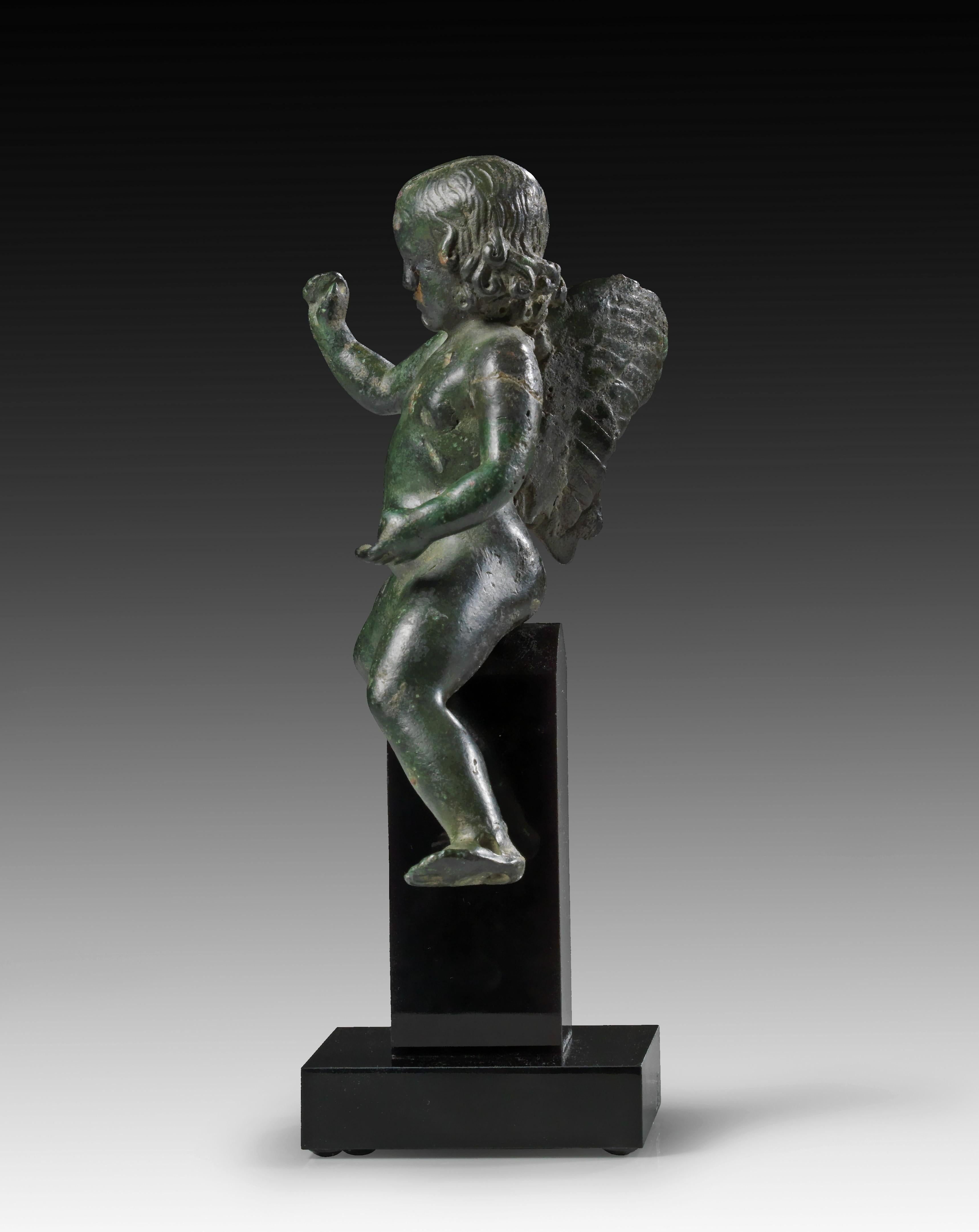 ANCIENT ROMAN BRONZE FIGURE OF WINGED EROS RIDING A DOLPHIN, 2ND CENTURY AD - Sculpture by Unknown