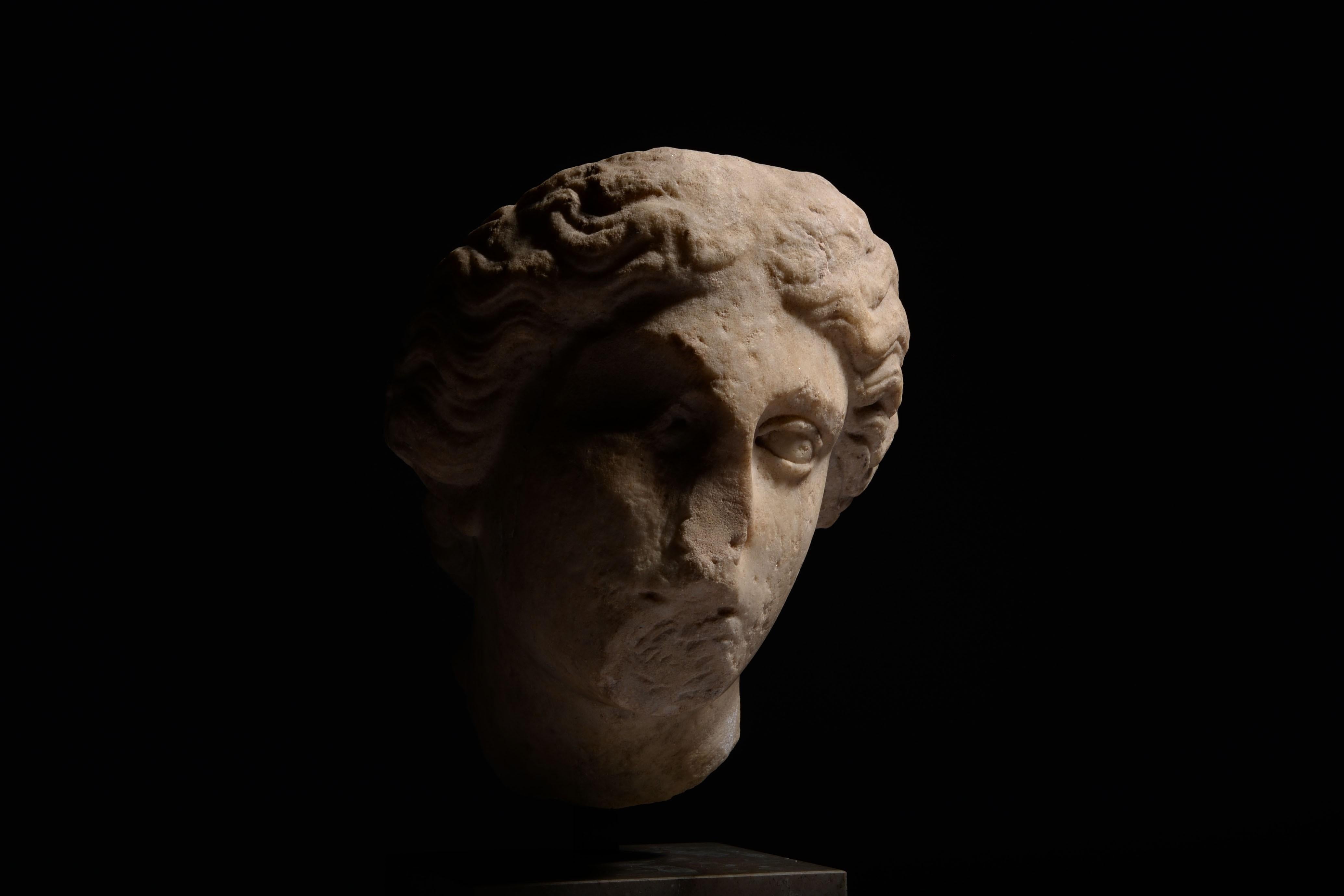 This beautiful marble head of Athena, or Minerva to the Romans, is full of pathos, with melancholic, almond-shaped eyes framed by a sweeping brow. An iron tenon protruding from the centre of her head was probably once used to attach a bronze