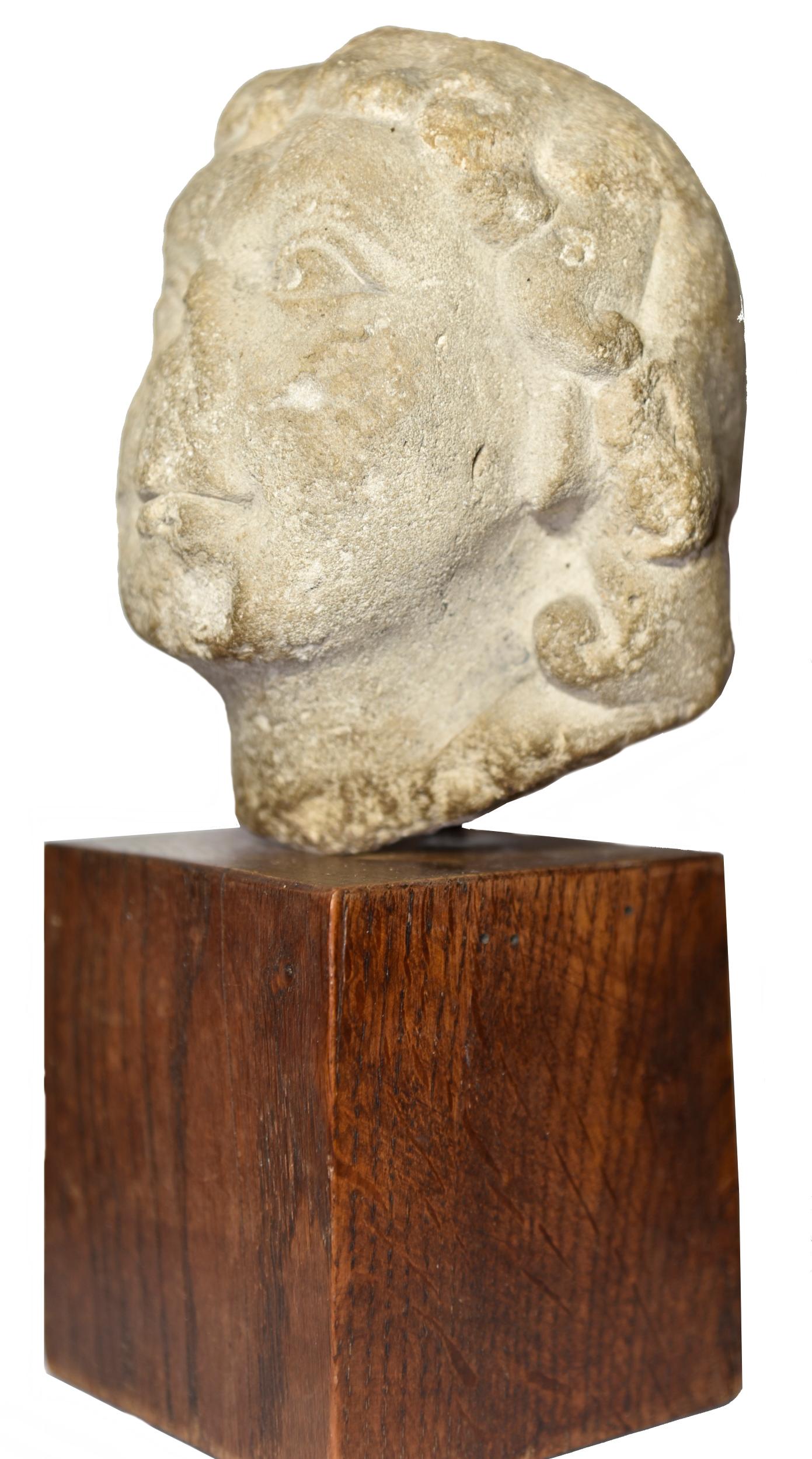 Romanesque head of Jesus child circa 1150 - Medieval Sculpture by Unknown