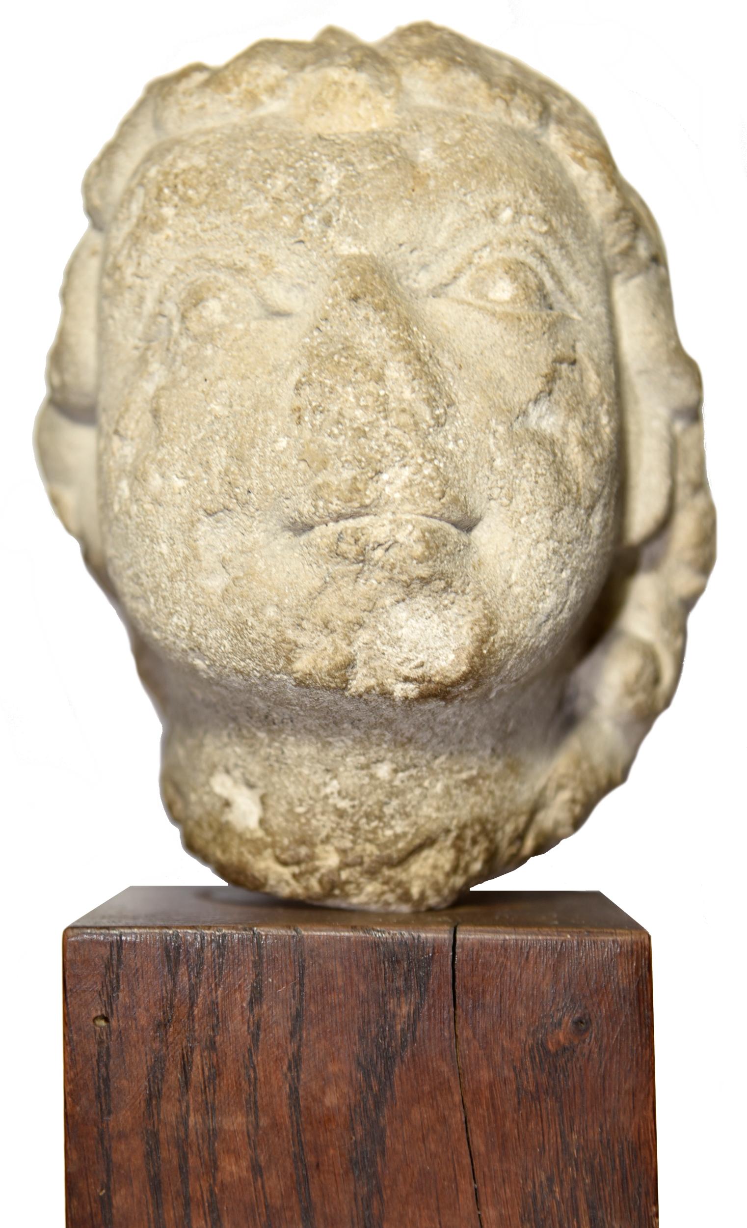 Romanesque head of Jesus child circa 1150 - Brown Figurative Sculpture by Unknown