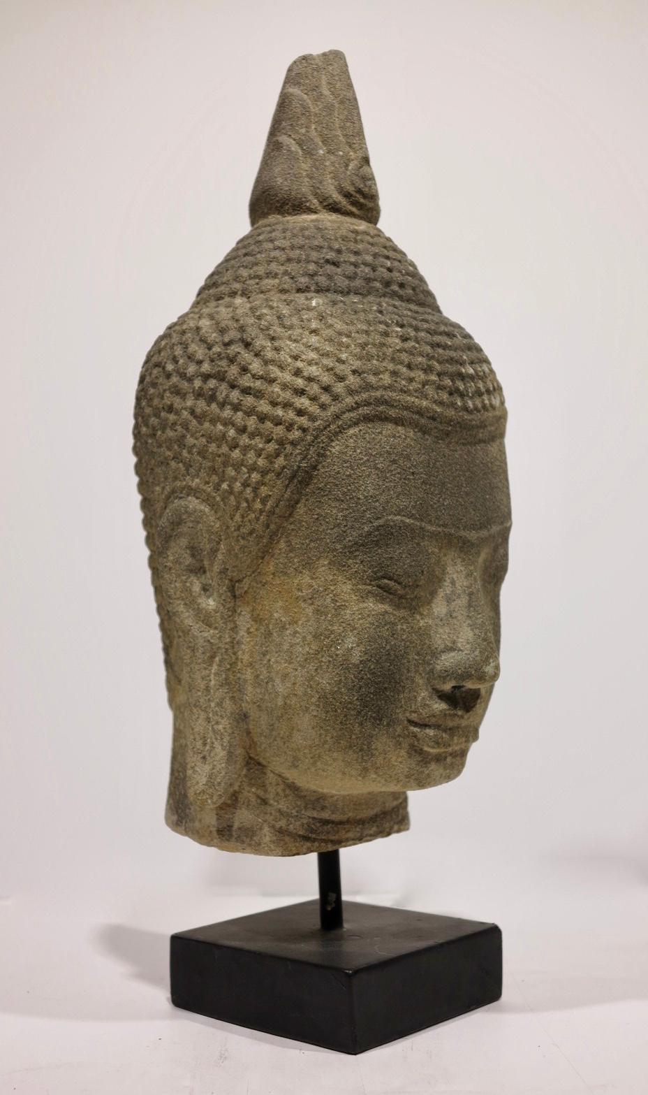 Sandstone head of Buddha, Khmer, Angkor period, post-Bayon - Sculpture by Unknown