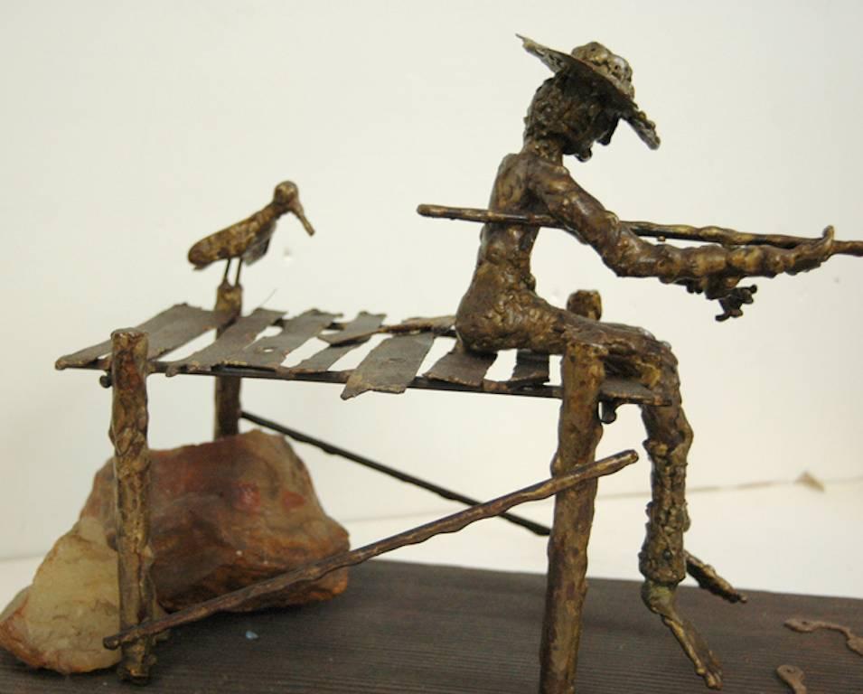 signed illegibly; Fisherman and Bird; bronze, wood, rock; h 11 x 20.5 x 7.5 in;