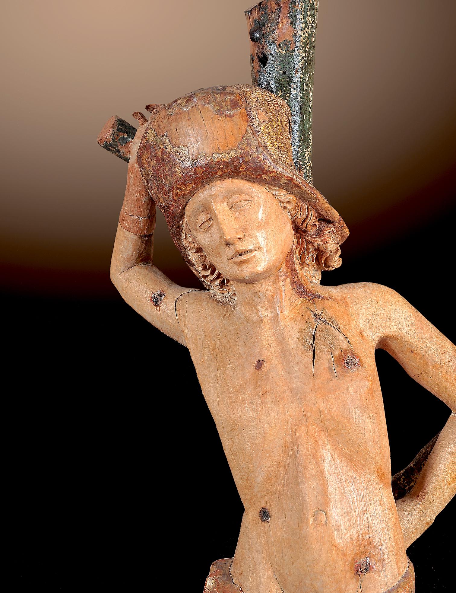 REMARKABLE SCULPTURE 
“St. Sebastian”
Tyrol/South Tyrol 
Around 1500 
Lime wood carved 
Remains of the original polychromy 
Height 70 cm 

The figure of Saint Sebastian (70 cm) was made in the Alpine region around 1500. The naked youth is depicted