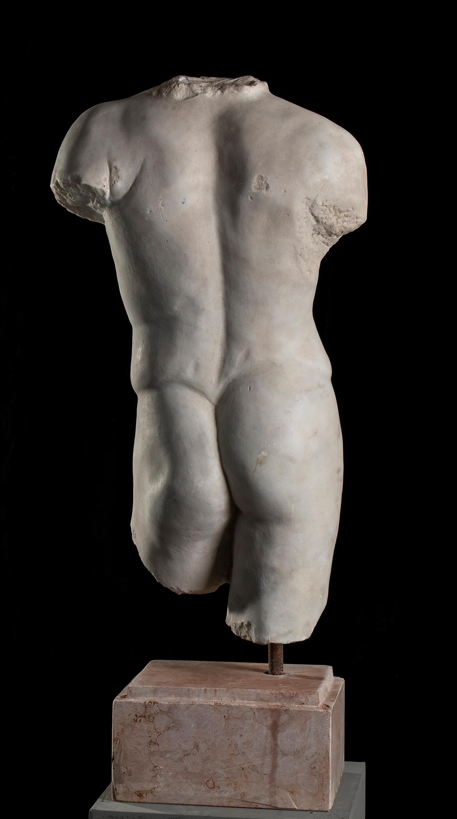 Over-lifesized, the youthful figure depicted nude, standing with his hip thrust to his right, his right arm originally raised, the left lowered and projecting slightly forward, the details of his musculature well defined and impressive is the