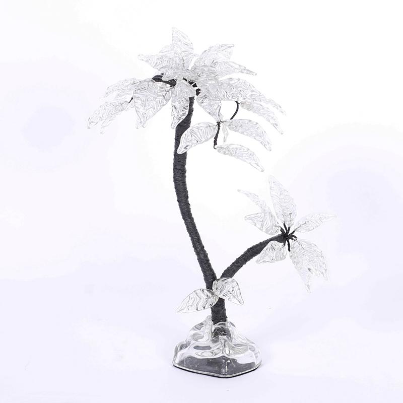 Palm tree sculpture crafted with glass leaves, wrapped metal trunk, and organic form glass base, all with a stylized modern vibe.