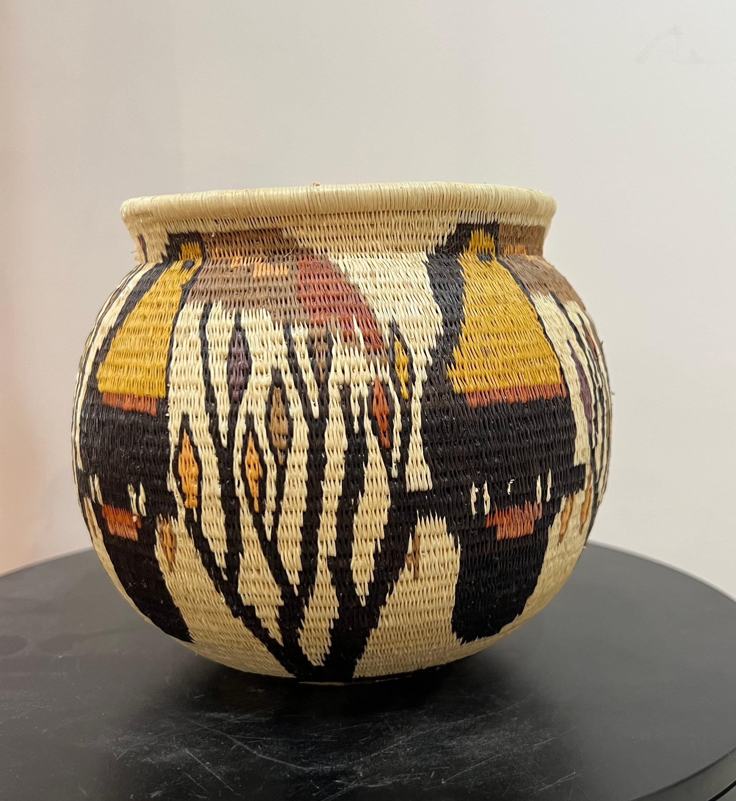 Toucan and Parrot Basket, yellow, cream, black, Tribal, Panama, Rainforest

The baskets are made by the Wounaan and Embera Indians from the Darien Rainforest in Panama.  The Wounaan believe they emerged from the palm tree. They weave baskets from