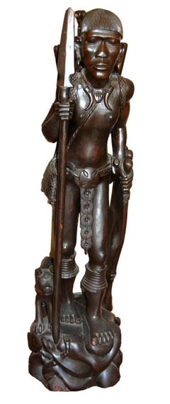 Two African sculptures of man; carved wood with Emu egg