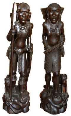 Two African sculptures of man; carved wood with Emu egg