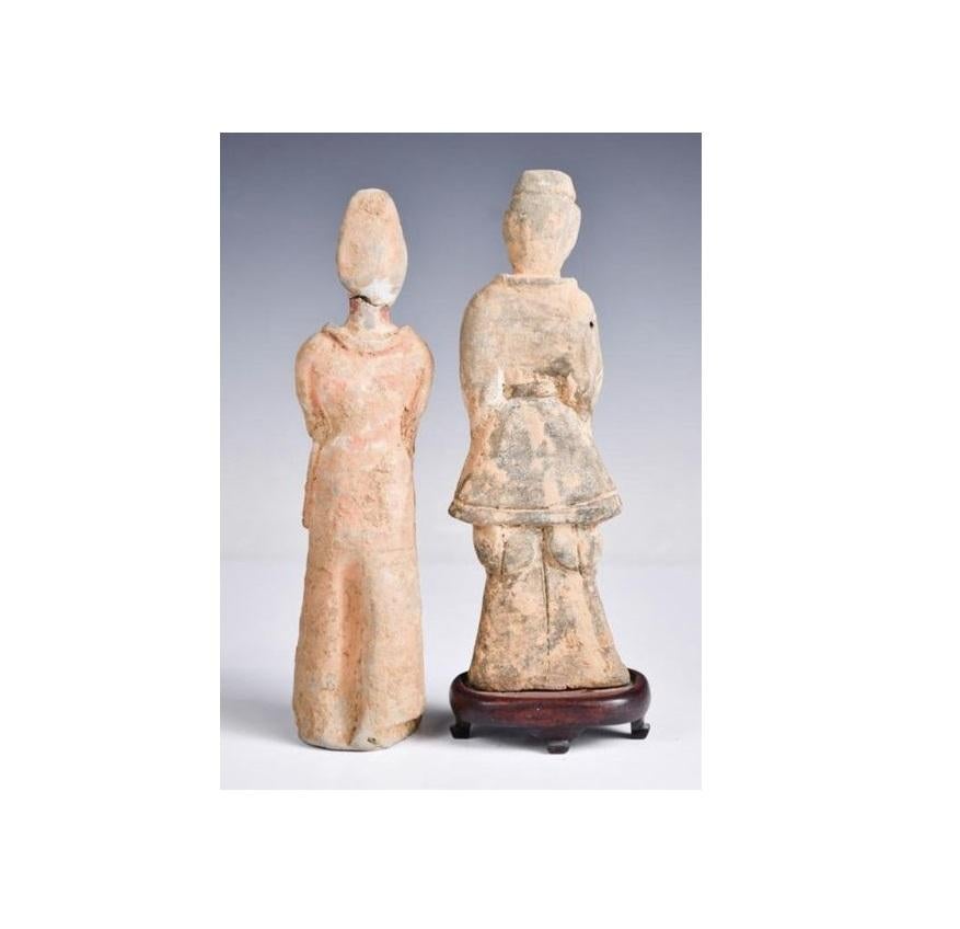 This set of two Earthenware Groom burial figures are from the Sui-Tang dynasty (581 - 618 AD). The two pieces are in great condition for their age with minor repairs to head and minimal wear for their age, featuring robes in red pigment and with