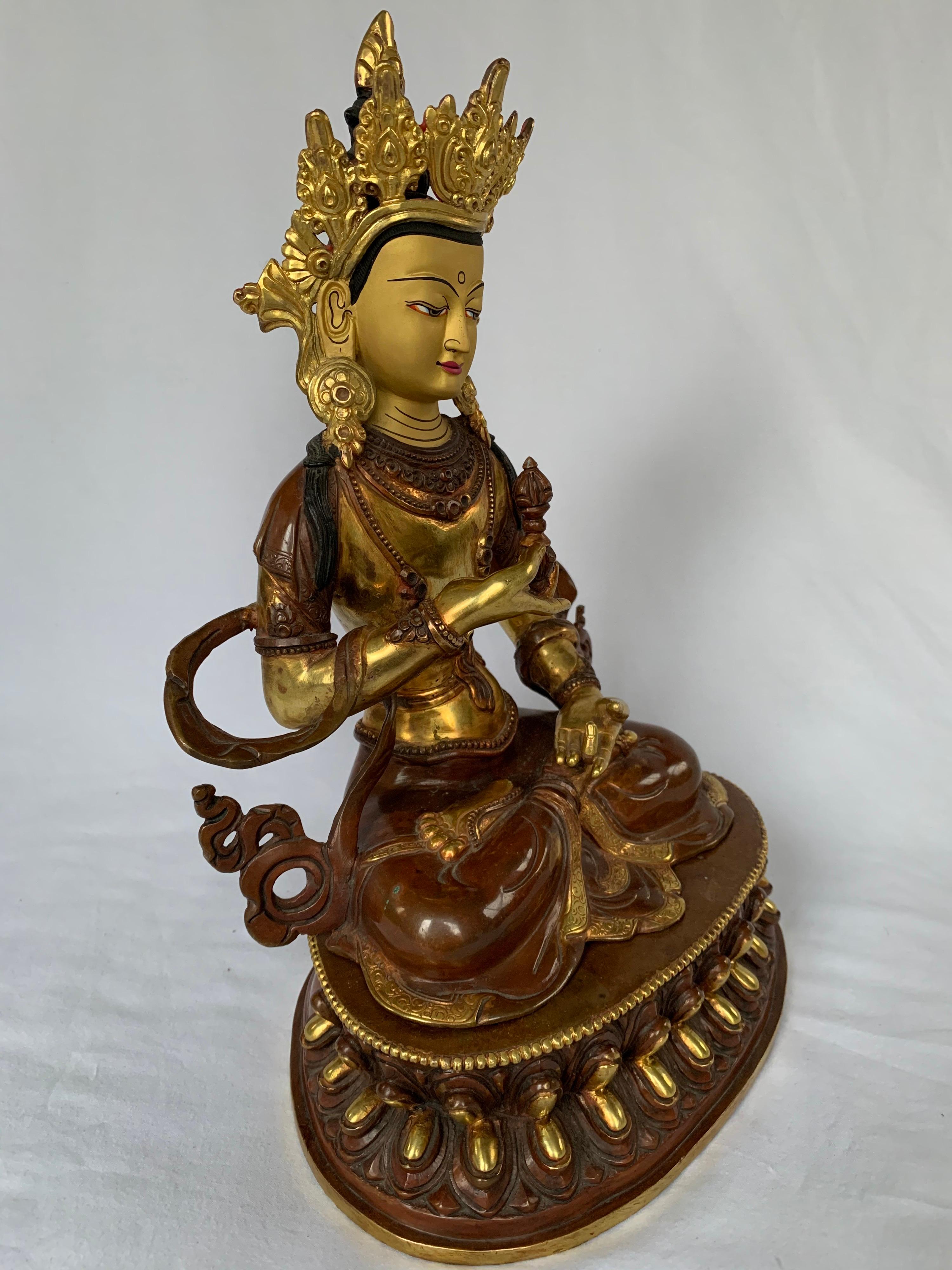 This statue is handcrafted by lost wax process which is one of the ancient process of metal craft. Vajrasattva is seated on lotus with one hand holding a Vajra which is a symbol of protection. 24K real gold plating is done on copper body and it