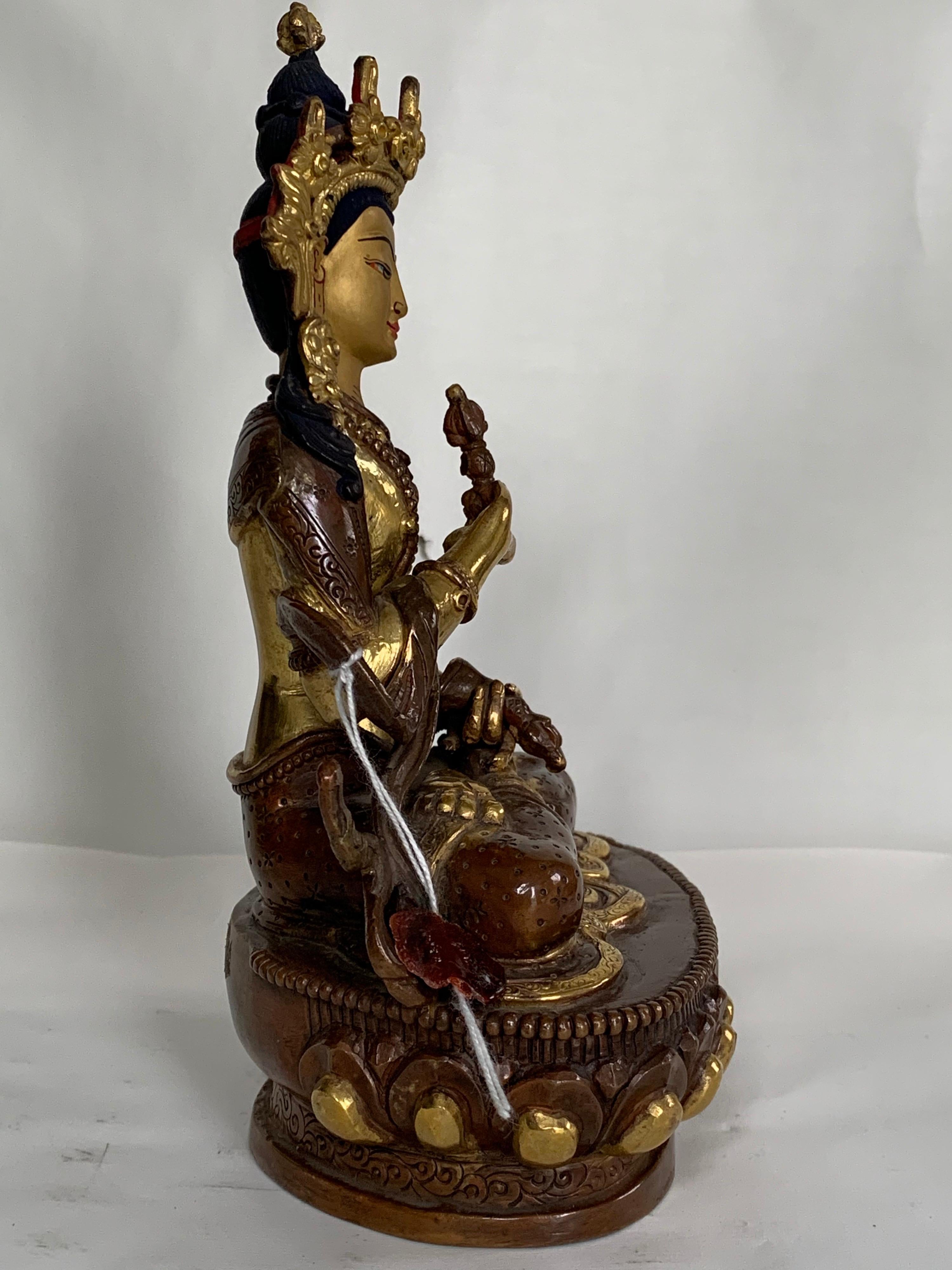 This statue is handcrafted by lost wax process which is one of the ancient process of metal craft. Vajrasattva is seated on lotus with one hand holding a Vajra and the other hand a bell. 24K real gold plating is done on copper body. 
A long process