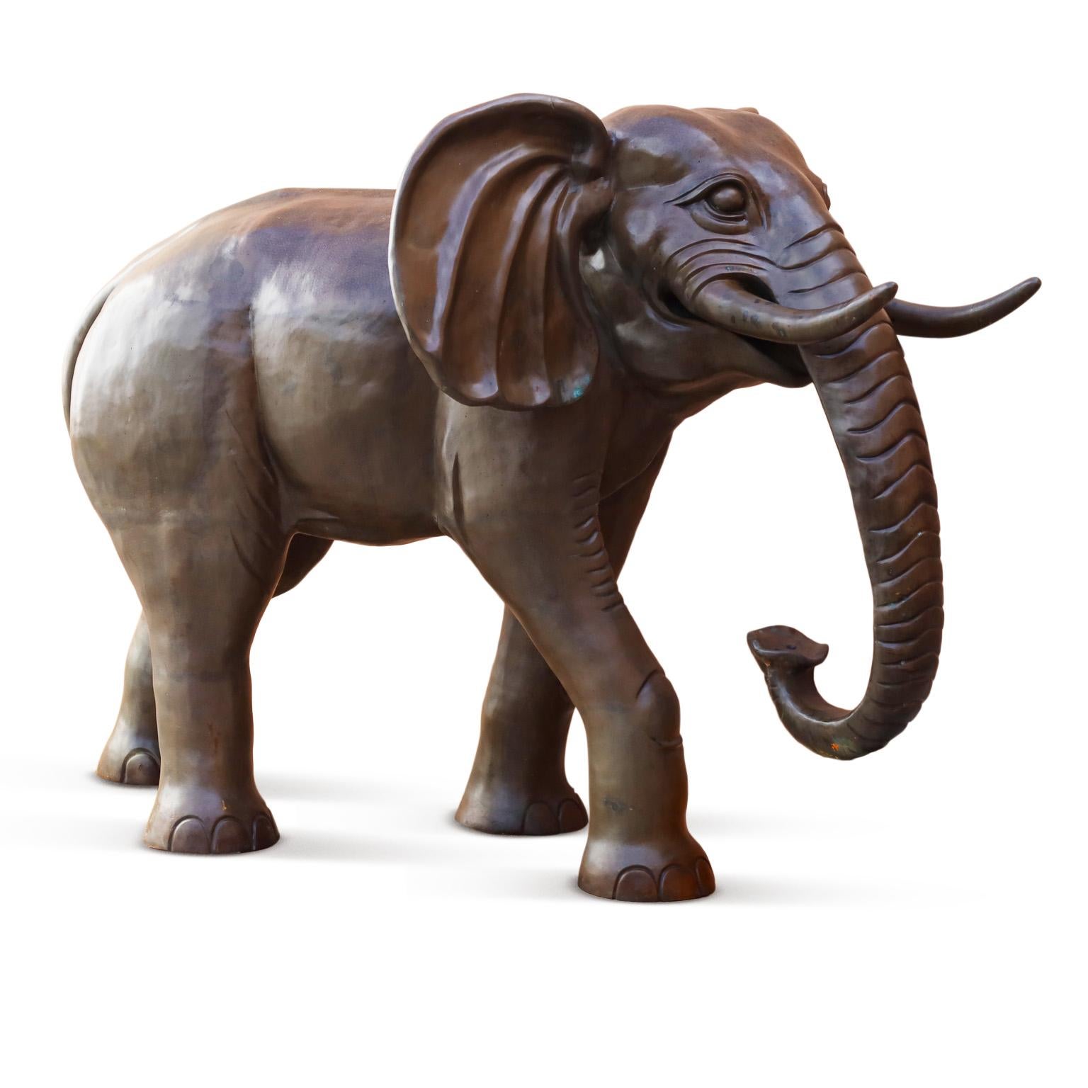 Rare and remarkable elephant sculpture expertly crafted in bronze with a lush patina, ambitious attention to detail, and a dramatic near life size scale.