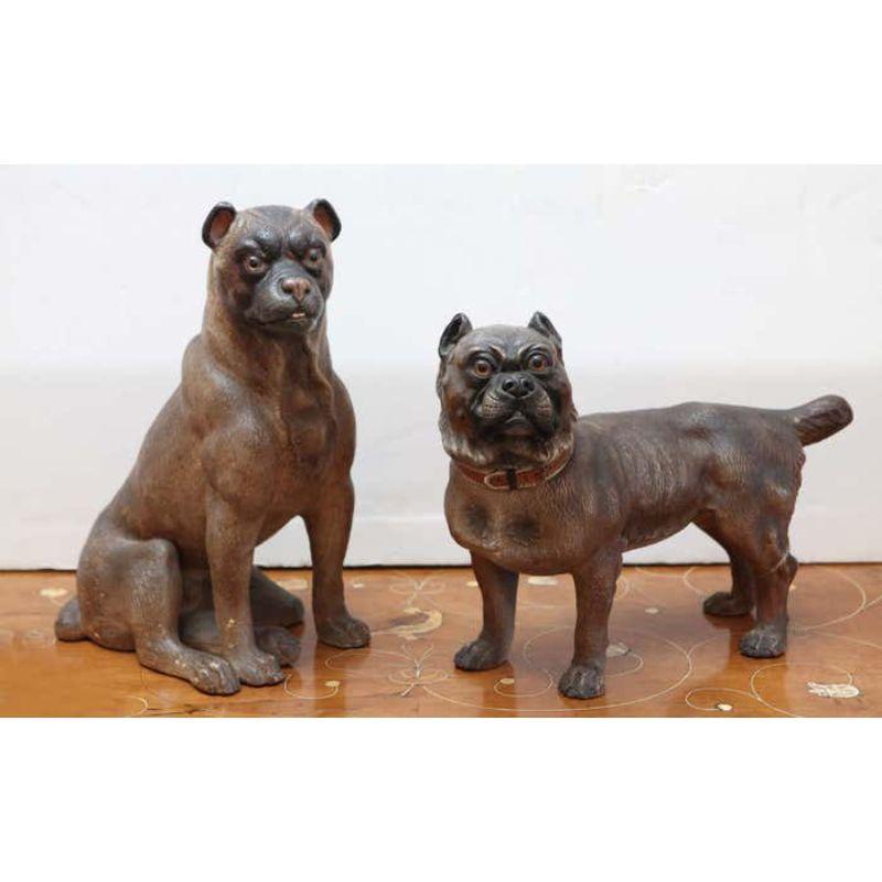 Pair of expressive, hand-painted, terracotta dogs with glass eyes from England.