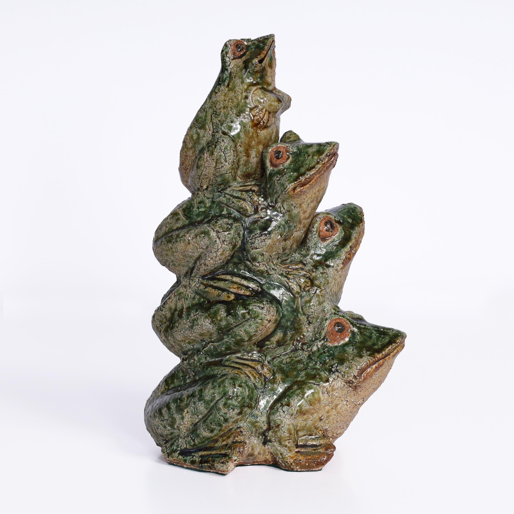 Whimsical Chinese sculpture or figure crafted in terracotta and hand decorated with a thick glaze depicting a game of leap frog gone awry. 