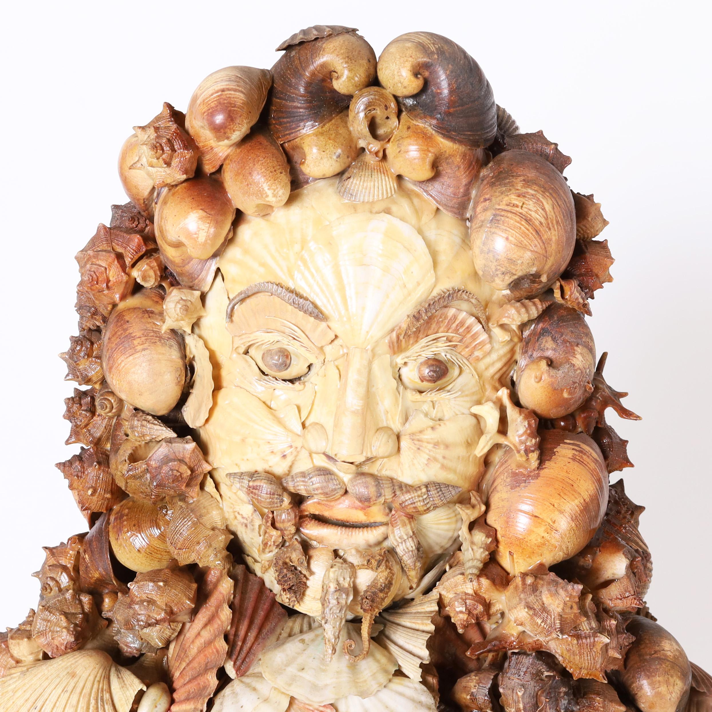 Whimsical Italian seashell encrusted bust with an eccentric composition depicting an 18th century dashing figure of a man complete with mustache and goatee. Presented on a custom wood and composition pedestal decorated with a fishing net.

Pedestal: