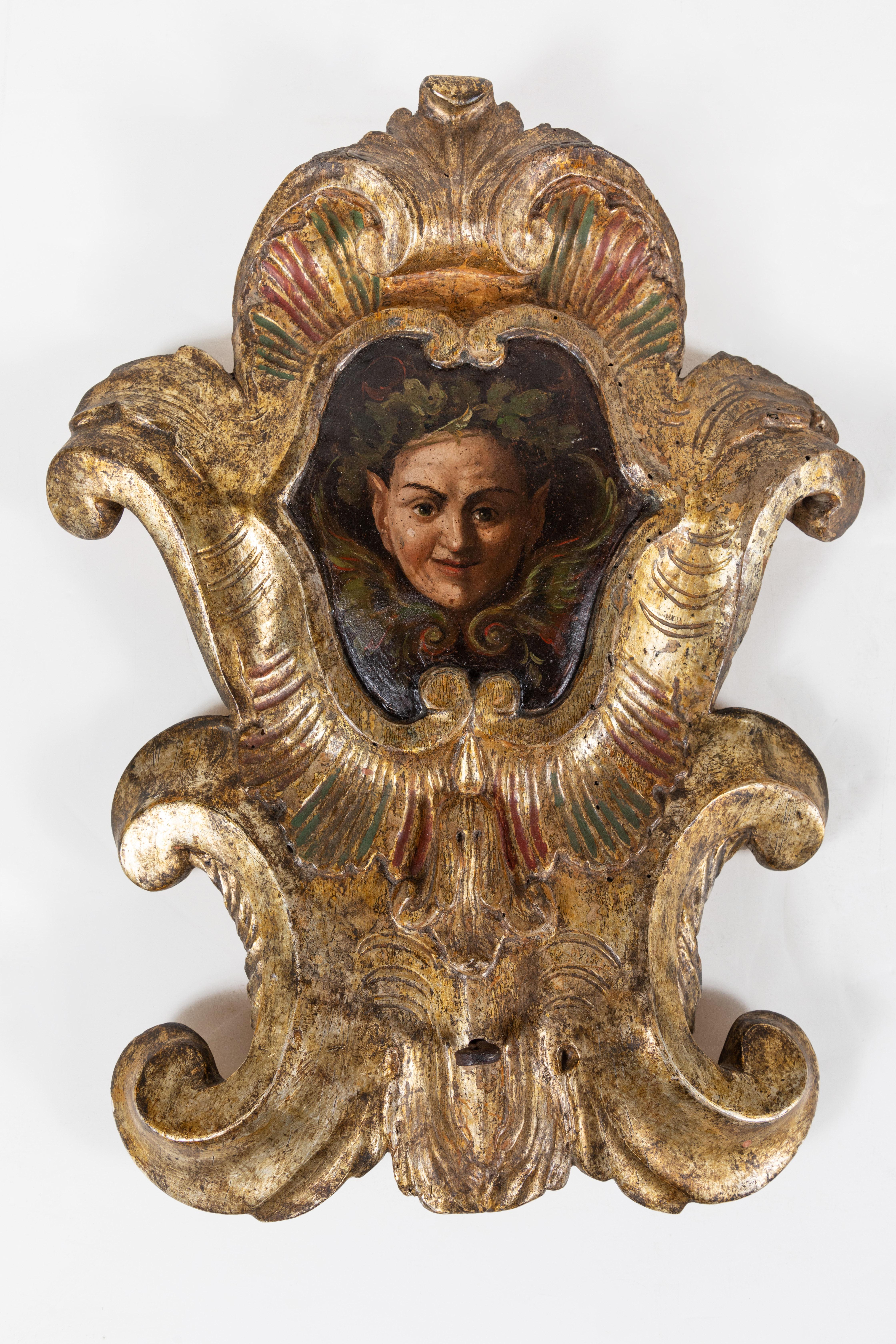 Charming, early 19th century, hand carved, gessoed, and 22-karat gold gilded, polychrome wall plaques featuring nature spirits surrounded by foliate wreaths. Each with wonderful, mischievous expressions.