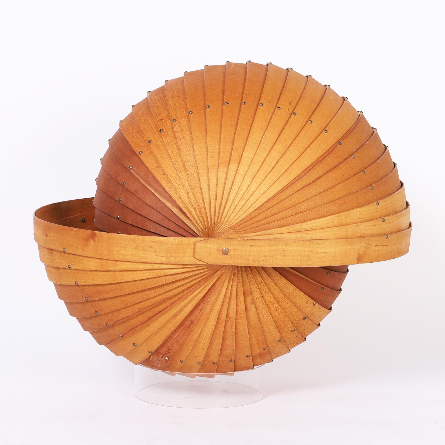 Mid century sculpture crafted in oak and ash woods with striking precision creating a mind blowing double sided nautilus seashell. Presented on a lucite base.