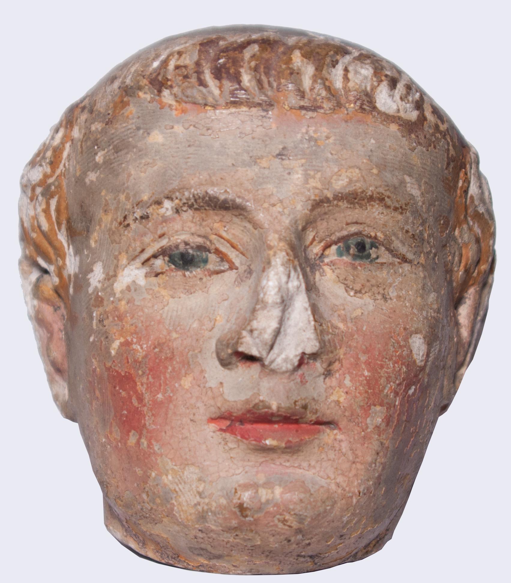 Fine head of a monk carved in limestone, with extensive and rare remnants of medieval polychromy.

Eyes in half-almond shape, chubby and cheerful face, the hair carved in packets, and generally a sharp and confident chisel indicate a French work of