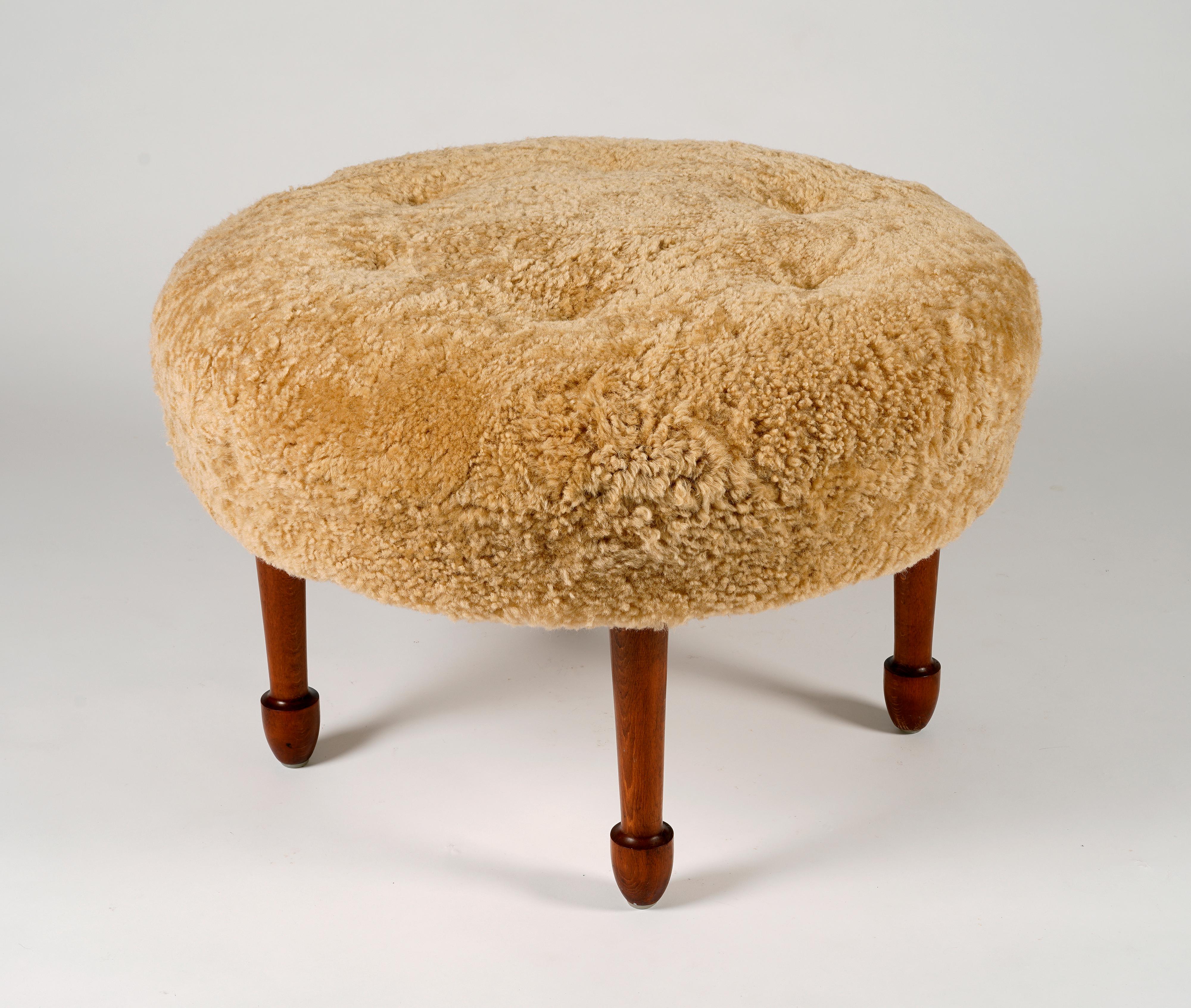 A oversized stool reupholstered in champagne coloured sheepskin. Legs in stained beech. Unknown swedish designer, in the manner of Josef Frank.

Due to the fact that several skins have been used, there may be irregularities in the structure of the