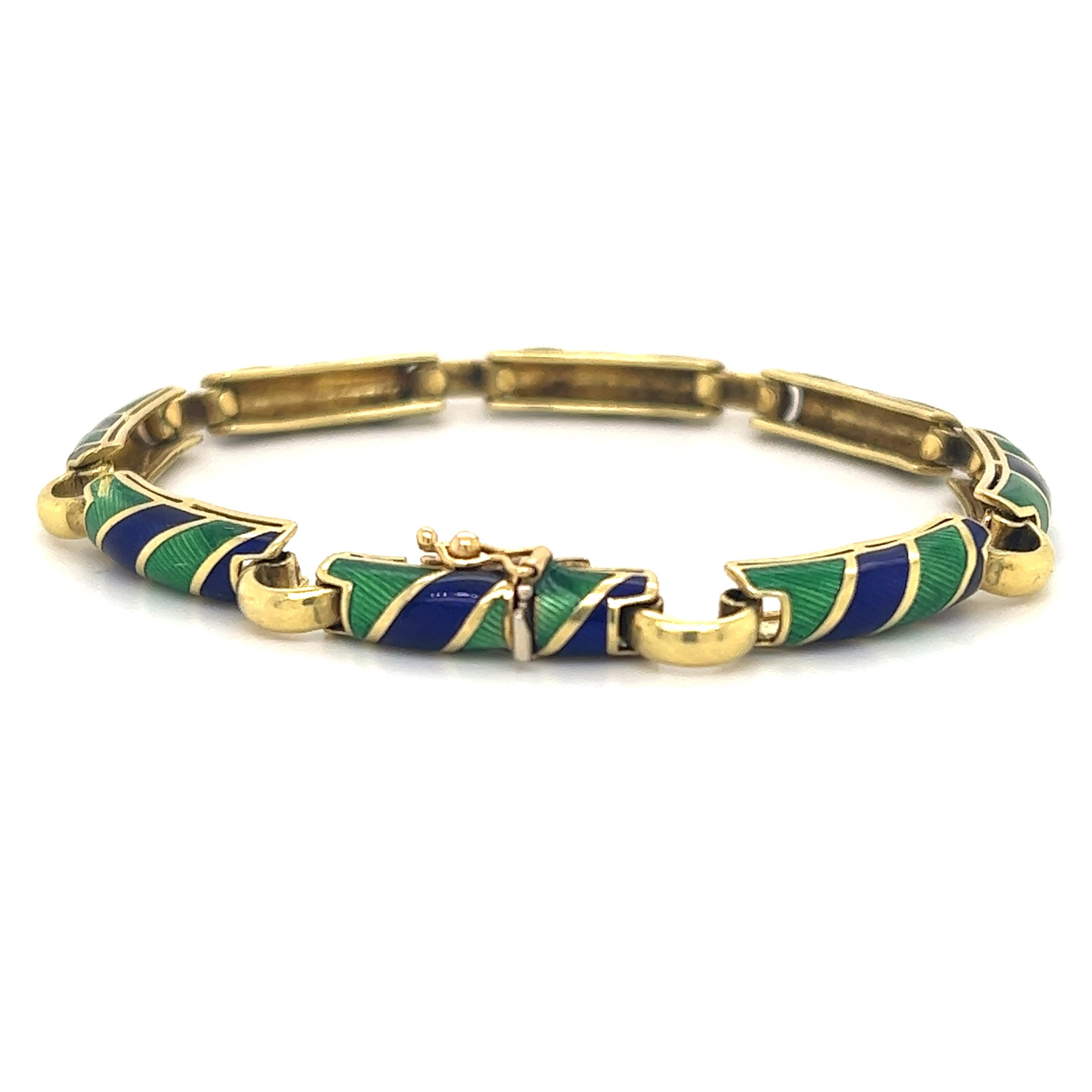 Beautiful bracelet crafted in 18k yellow gold. The bracelet is crafted by famed Italian designer Uno-A-Erre.  The bracelet is highlighted with guiloche enamel in green and blue.  The green and blue colors on this bracelet are vibrant and contrast