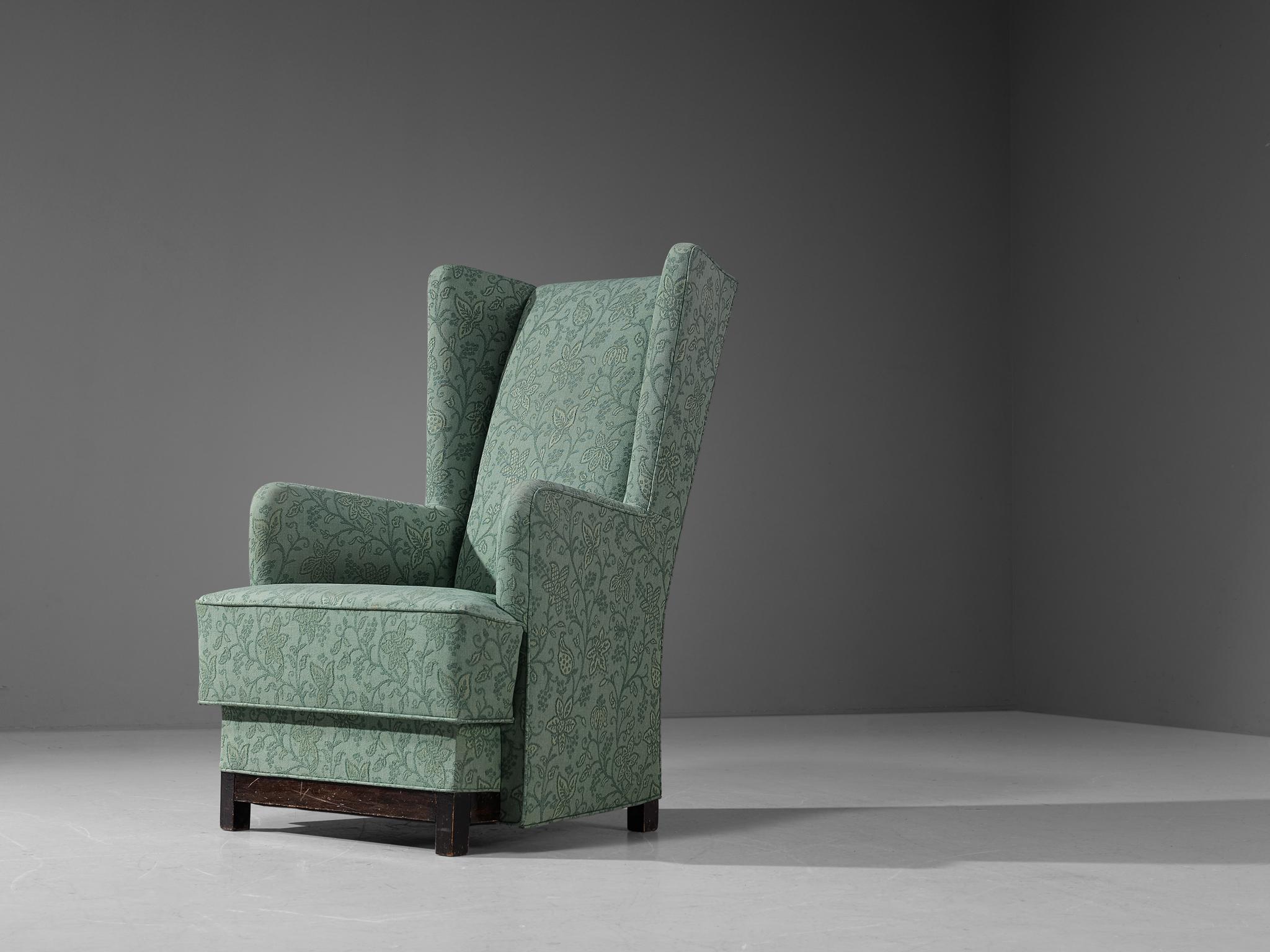Attributed to Uno Åhrén and Björn Trägårdh for Svenskt Tenn, easy chair, fabric, stained wood, Sweden, 1930s.

This lounge chair of Swedish origin comes with a mint green upholstery adorned with floral motifs. The design is based on a solid