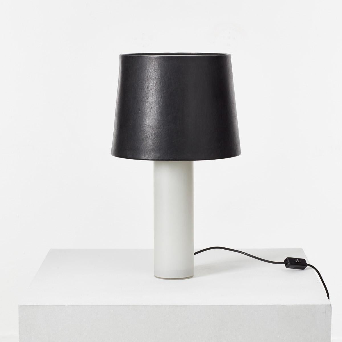 This elegantly refined milk glass table lamp was designed by brothers Uno and Osten Kristiansson for Swedish manufacturer Luxus. Designed circa 1960 this piece demonstrates the designers’ clear Swedish modern aesthetic.

The lamp base is made from