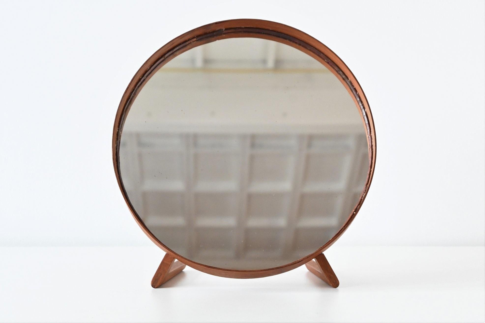 Wonderful table mirror designed by Uno and Östen Kristiansson for Luxus, Sweden 1960. The elegant simplicity of the form is nicely contrasted with the texture and richness of the teak. This mirror is very well crafted with nice dovetail connections