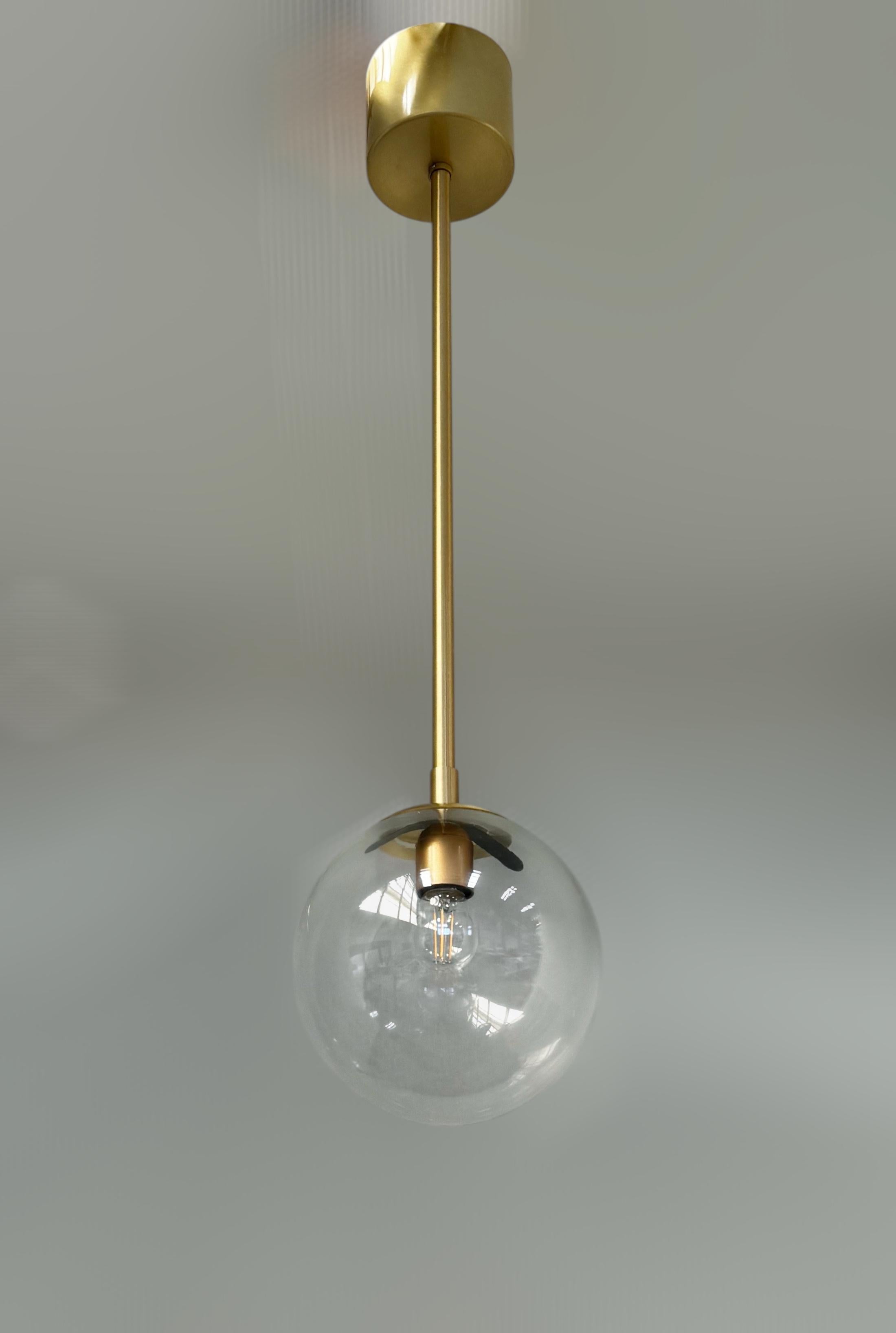 Italian pendant with clear Murano glass globe mounted on brass frame in satin brass finish / Made in Italy 
Designed by Fabio Ltd, inspired by Angelo Lelli and Arredoluce styles 
1 light / E12 or E14 type / max 40W each 
Height: 31 inches /