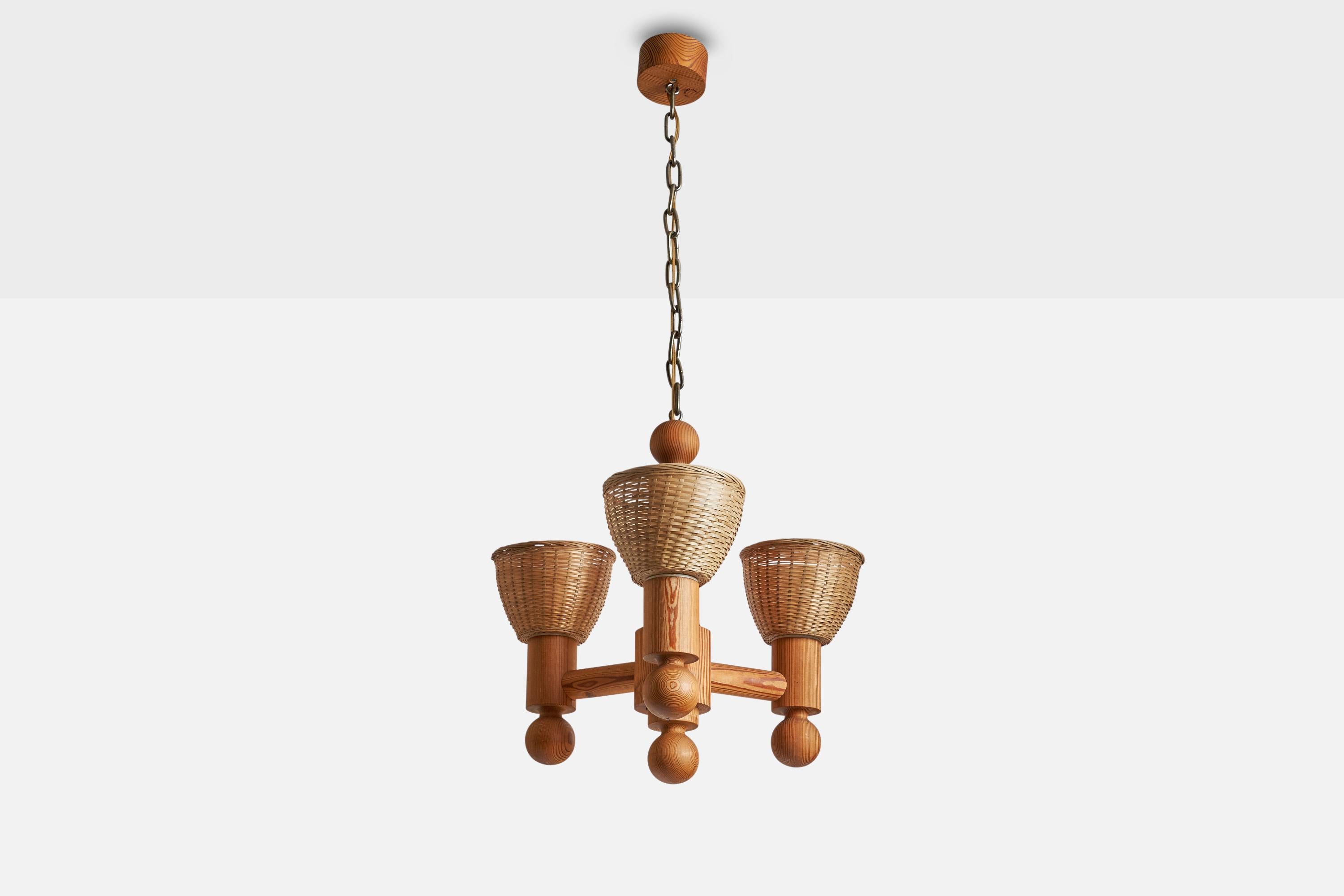 A pine and rattan chandelier designed by Uno and Östen Kristiansson and produced by Luxus, Vittsjö, Sweden, 1970s.

Dimensions of canopy (inches): 2.25” H x 4” Diameter
Socket takes standard E-26 bulbs. 3 sockets.There is no maximum wattage stated
