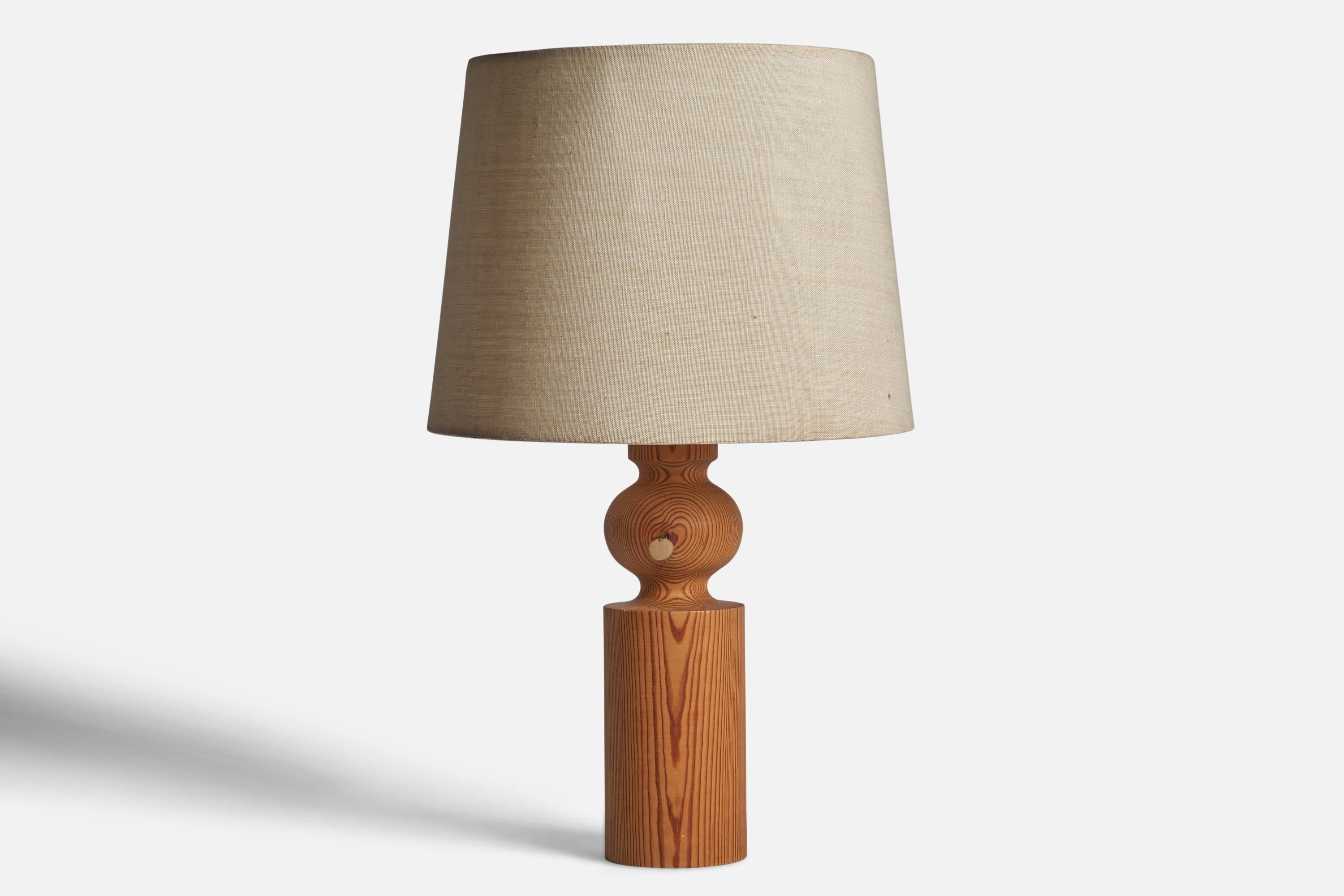 A pine and beige fabric table lamp designed by Uno Kristiansson and produced by Luxus, Vittsjö, Sweden, 1960s.

Overall Dimensions (inches): 20.85” H x 12” Diameter
Bulb Specifications: E-26 Bulb
Number of Sockets: 1
All lighting will be converted