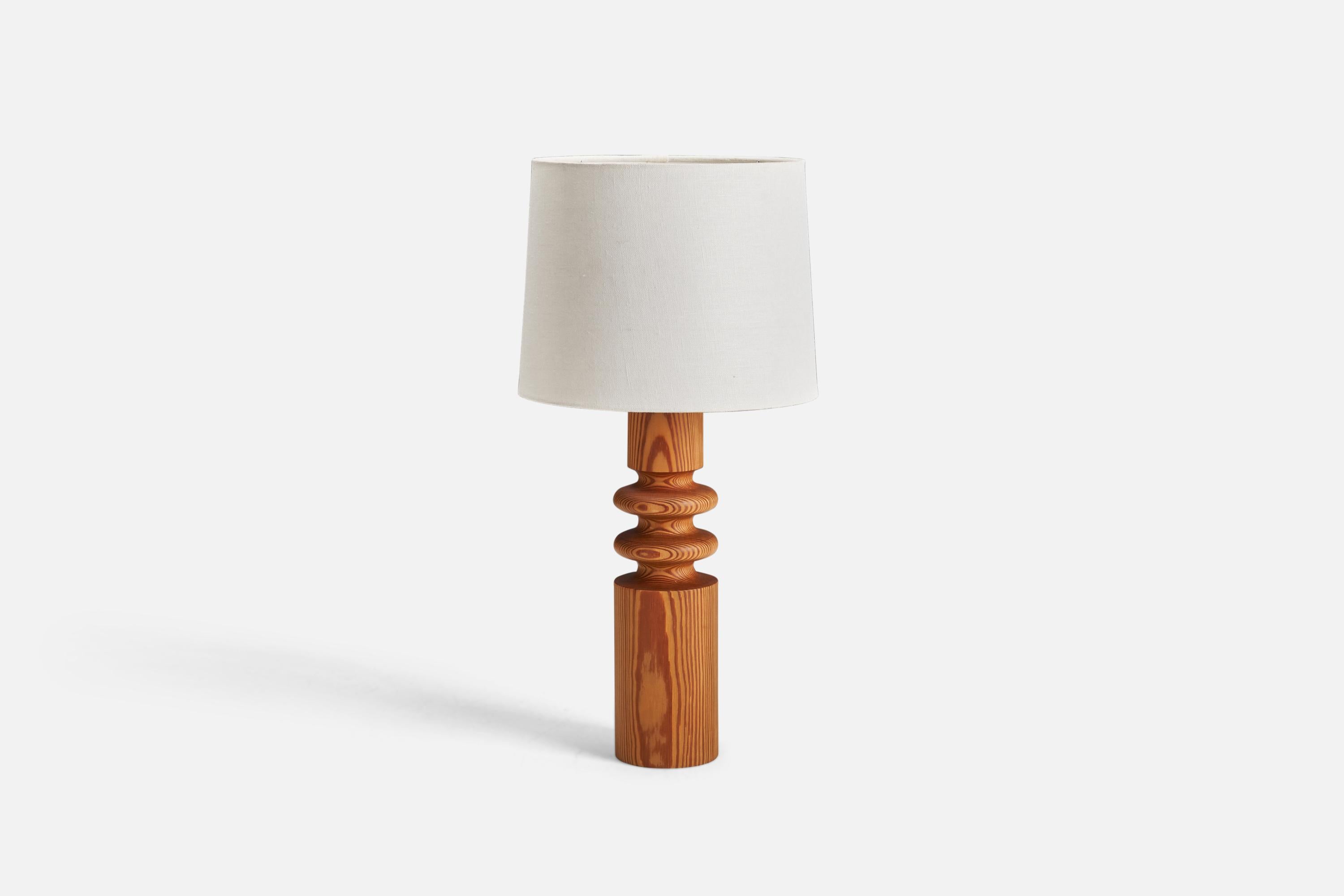 A pine table lamp designed by Uno Kristiansson and produced by Luxus, Sweden, 1970s.

Dimensions of Lamp (inches) : 14.43 x 3.56 x 3.56 (Height x Width x Depth)
Dimensions of Lampshade (inches) : 9 x 10 x 8 (Top Diameter x Bottom Diameter x