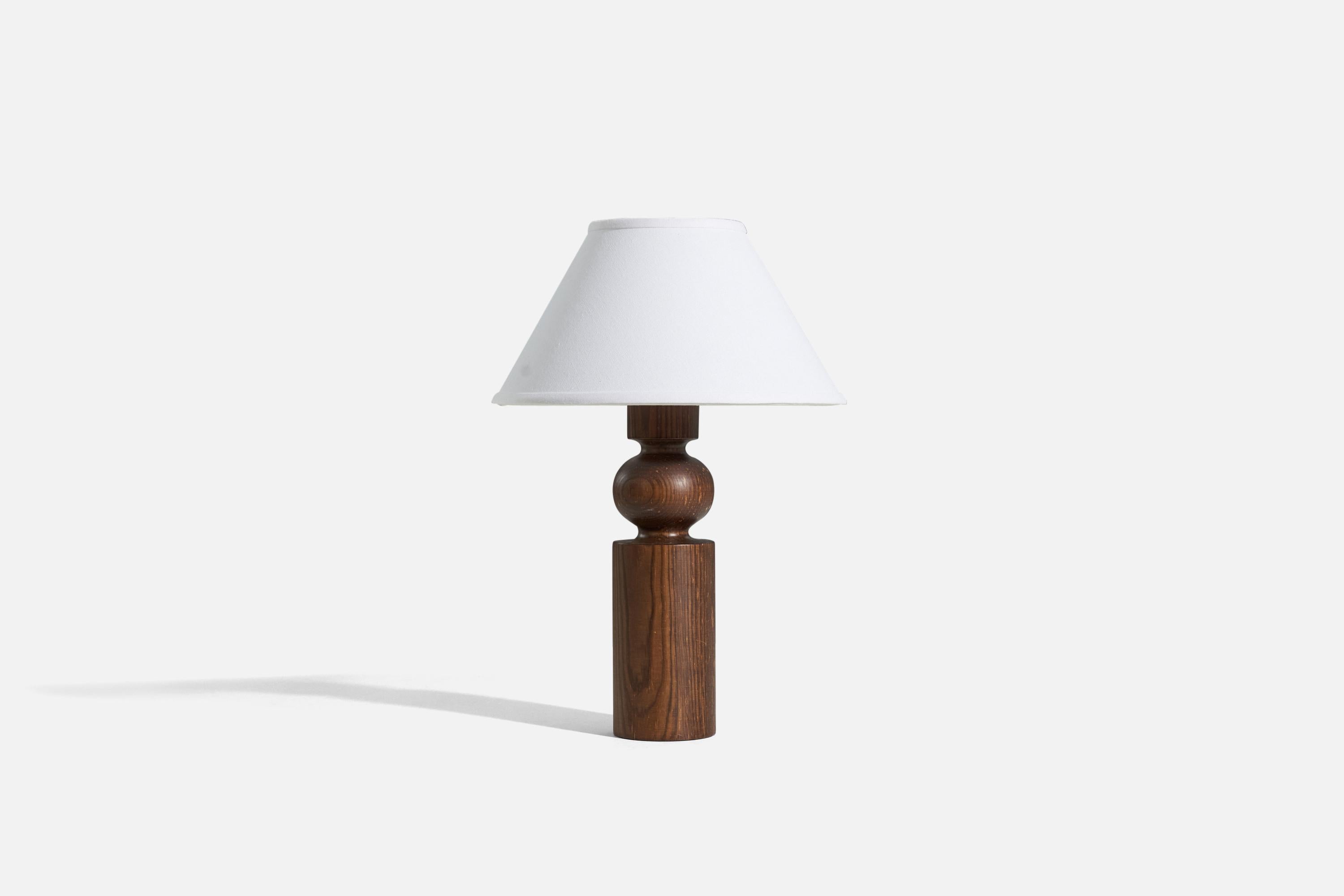 A solid pine table lamp designed by Uno Kristiansson and produced by Luxus, Sweden, 1960s.

Sold without lampshade. 
Dimensions of Lamp (inches) : 14.375 x 3.5 x 3.5 (H x W x D)
Dimensions of Shade (inches) : 5 x 12.25 x 7.25 (T x B x