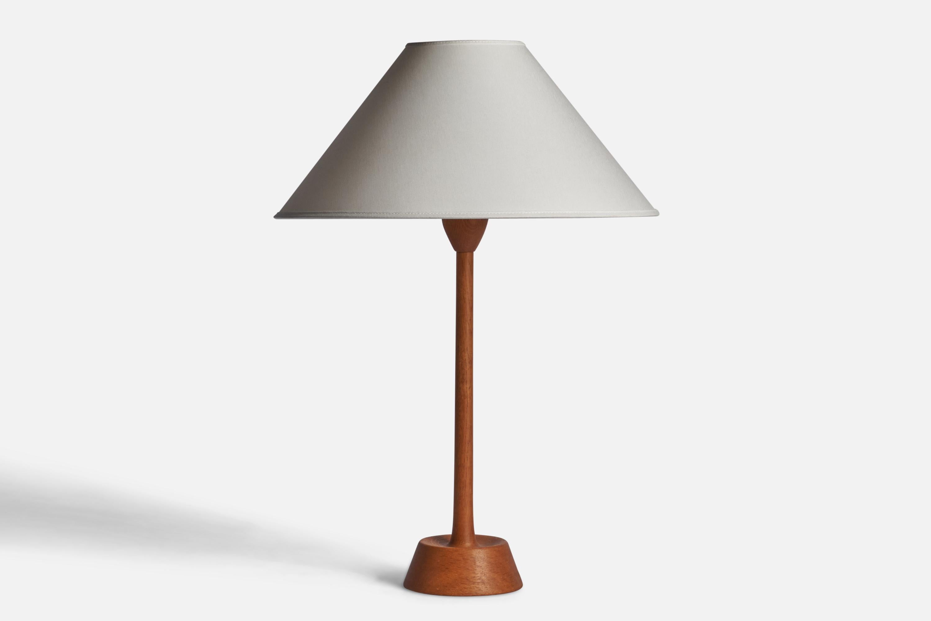 A teak table lamp designed and produced by Uno Kristiansson, Sweden, 1960s.

Dimensions of Lamp (inches): 17.75” H x 5” Diameter
Dimensions of Shade (inches): 4.5” Top Diameter x 16” Bottom Diameter x 7.25” H
Dimensions of Lamp with Shade (inches):