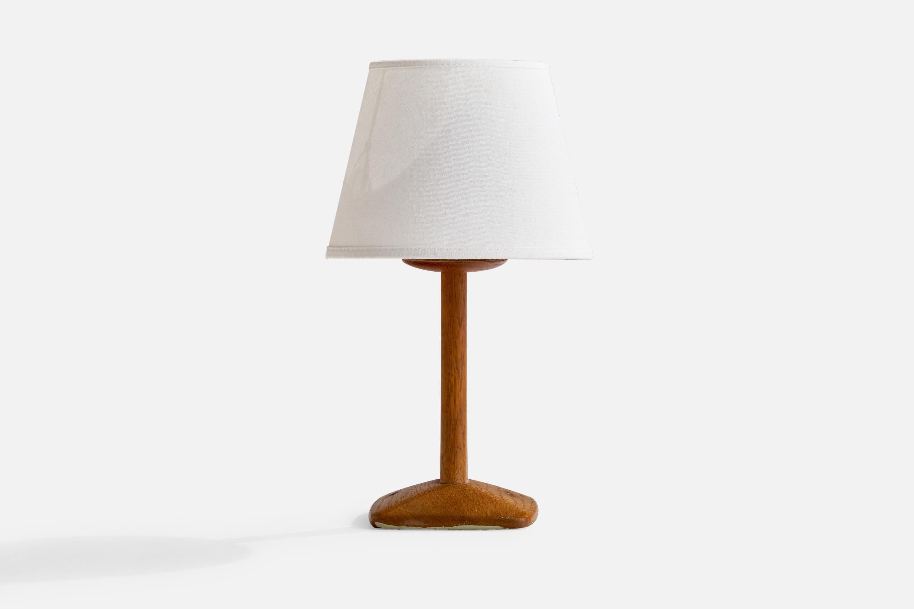 A teak table lamp designed by Uno and Östen Kristiansson and produced by Luxus, Vittsjö. Sweden, c. 1960s.

Overall Dimensions (inches): 14” H x 7.75” W x 5.1” D
Stated dimensions include shade.
Bulb Specifications: E-26 Bulb
Number of Sockets: