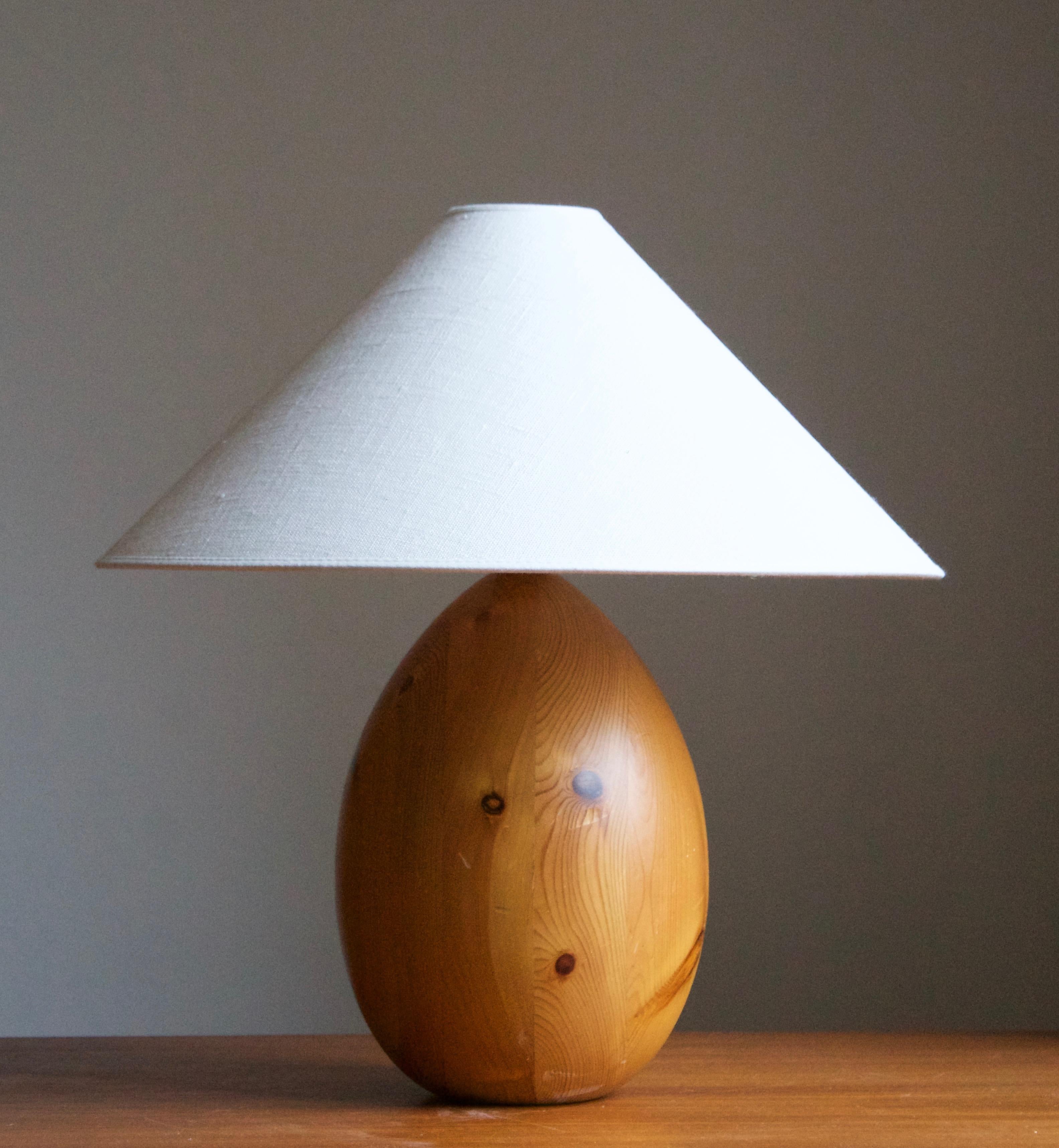 A sculptural solid pine table lamp. Designed by Uno Kristiansson, for Luxus, Sweden, 1970s. Labeled.

Stated dimensions exclude lampshade, height includes socket. Sold without lampshade.

Other designers of the period include Axel Einar Hjorth,