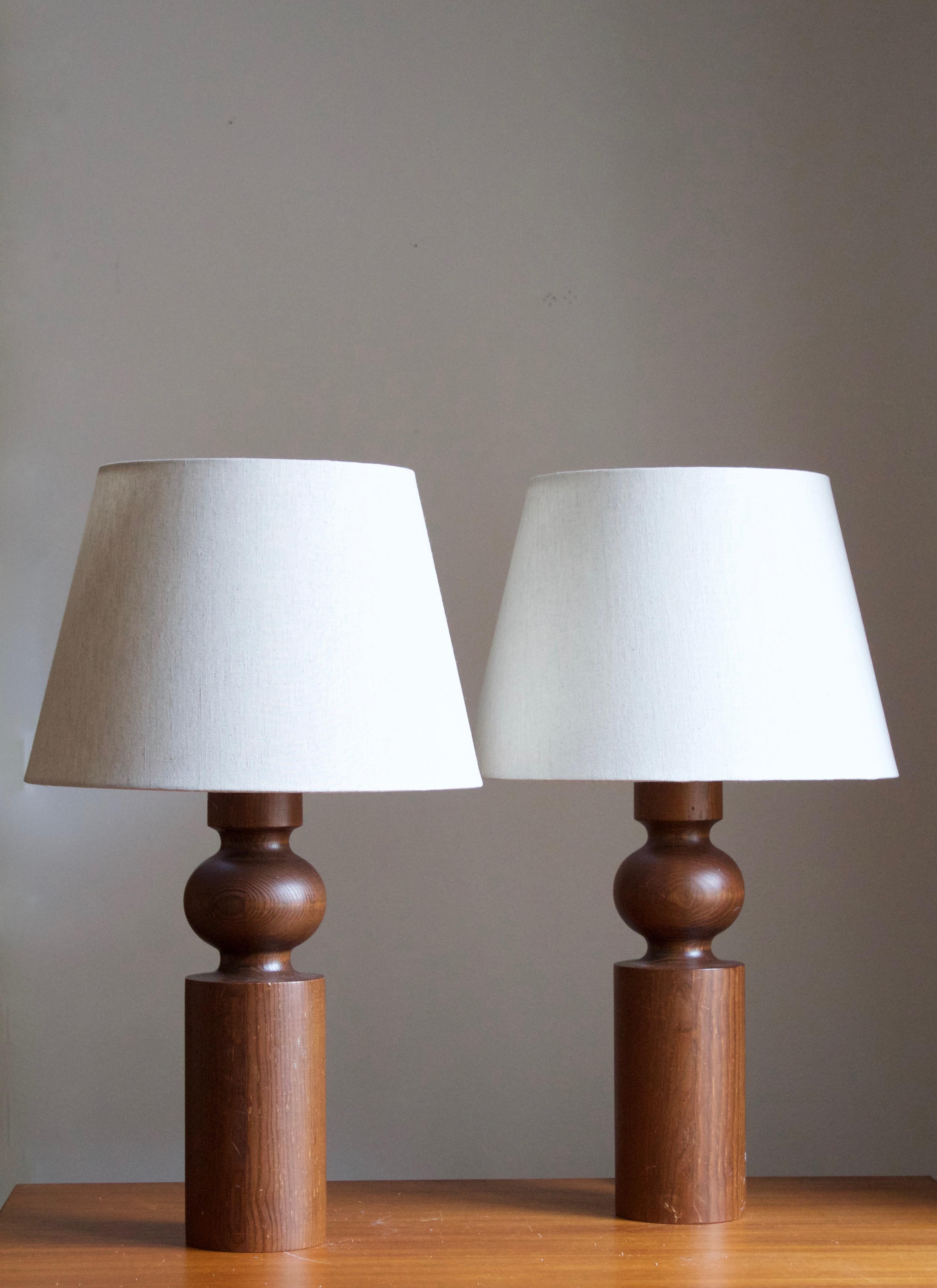 A pair of solid pine table lamps. Designed by Uno Kristiansson, for Luxus, Sweden, 1960s.

Stated dimensions exclude lampshade, height includes socket. Shades are not included in purchase.

Other designers of the period include Axel Einar Hjorth,