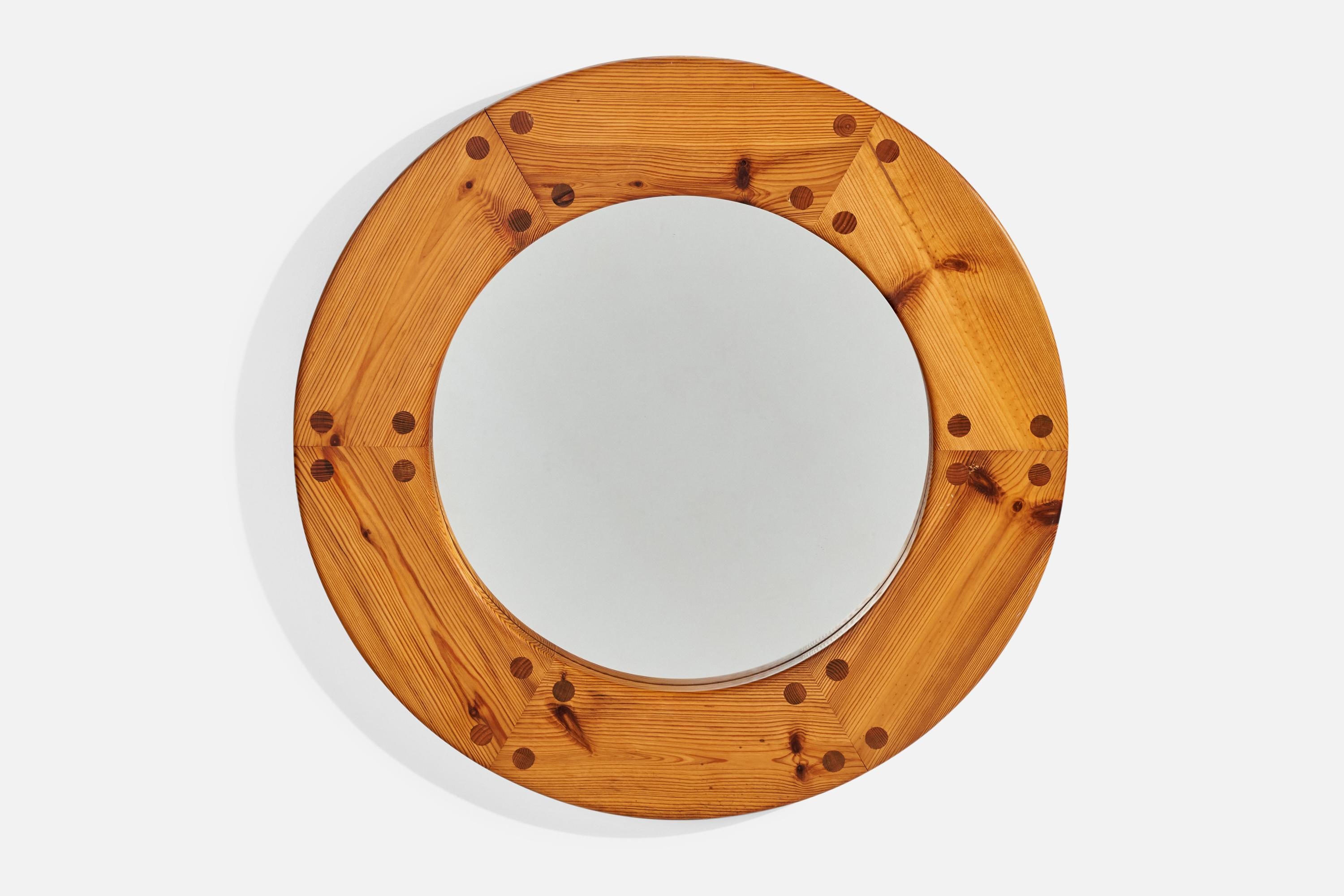 A round pine wall mirror designed by Uno Kristiansson and produced by Luxus, Vittsjö, Sweden, 1970s.