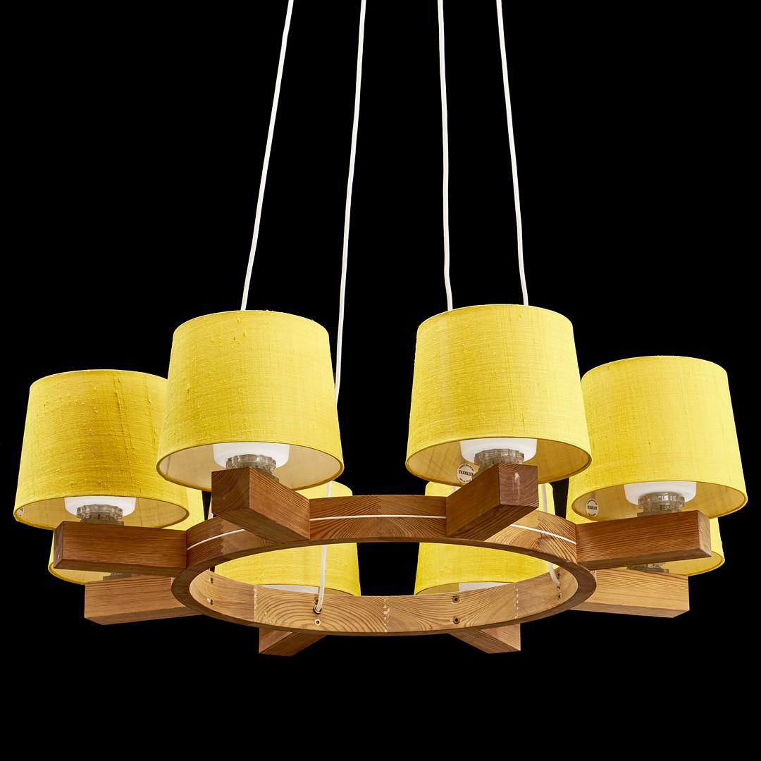 Designed by Uno & Östen Kristiansson in the 1960s in Sweden for Luxus, Vittsjö.
A pine wood ring with eight arms and yellow Texolux shades made of Thai silk. 
