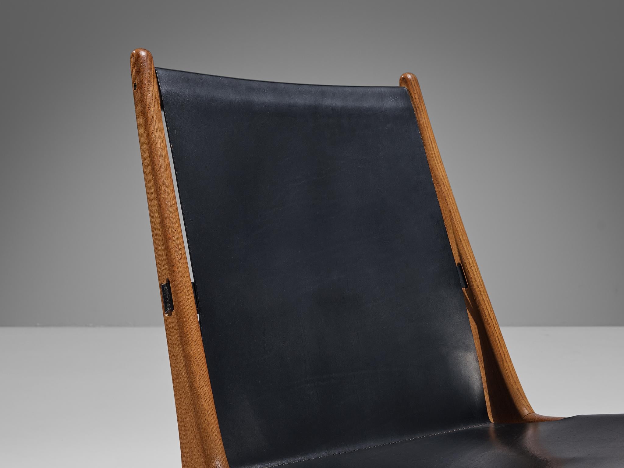 Cuir Uno & Östen Kristiansson pour Luxus Chaise de chasse en cuir et chêne en vente