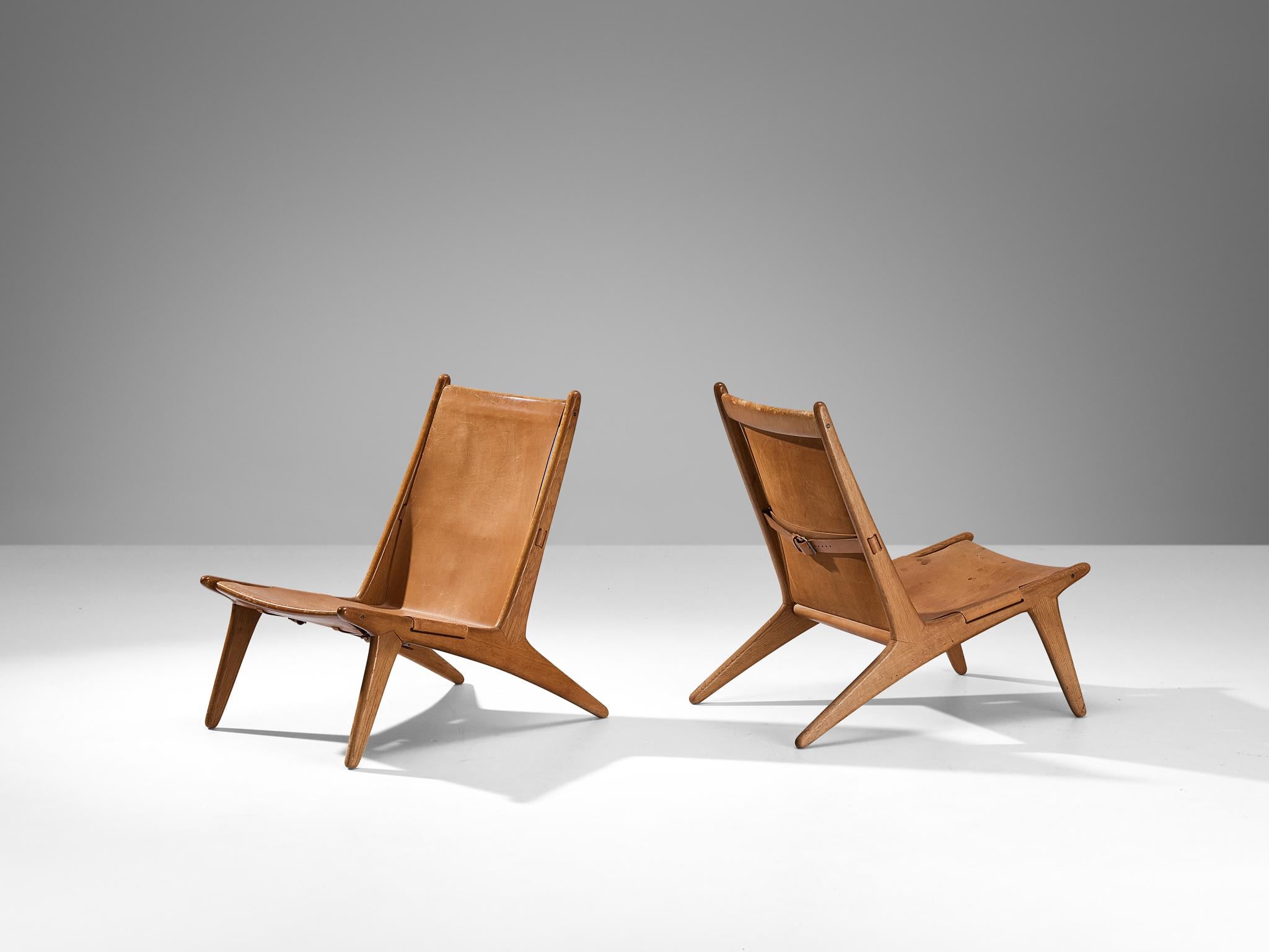 Uno & Östen Kristiansson for Luxus, pair of hunting chairs, model '204', leather, oak, Sweden, 1954

Swedish hunting chairs designed by Uno & Östen Kristiansson in the fifties. This unique design has a very strong appearance. The sleek construction