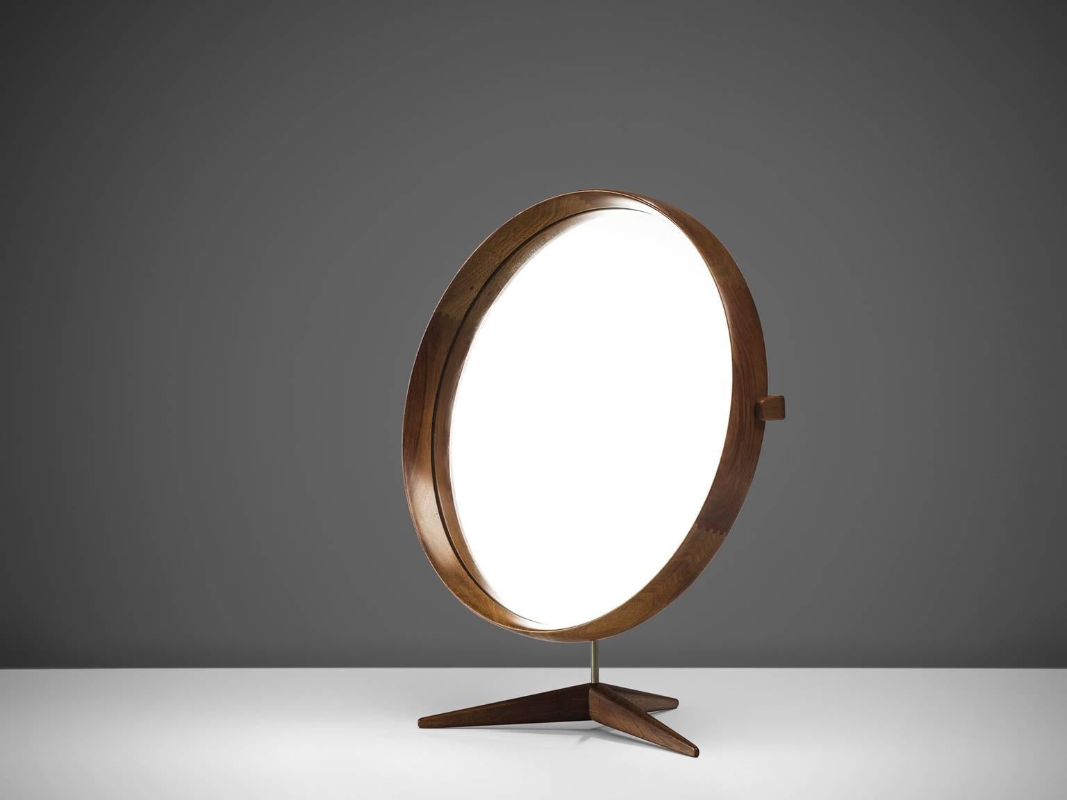 Uno & Osten Kristiansson, round mirror walnut and steel, Sweden, 1960s. 

This mirror is held by a steel tube which has a base of three legs, the mirror is mad by Luxus Vittsjö Des Uno Östen Kristiansson. The frame circulates the glass and is made