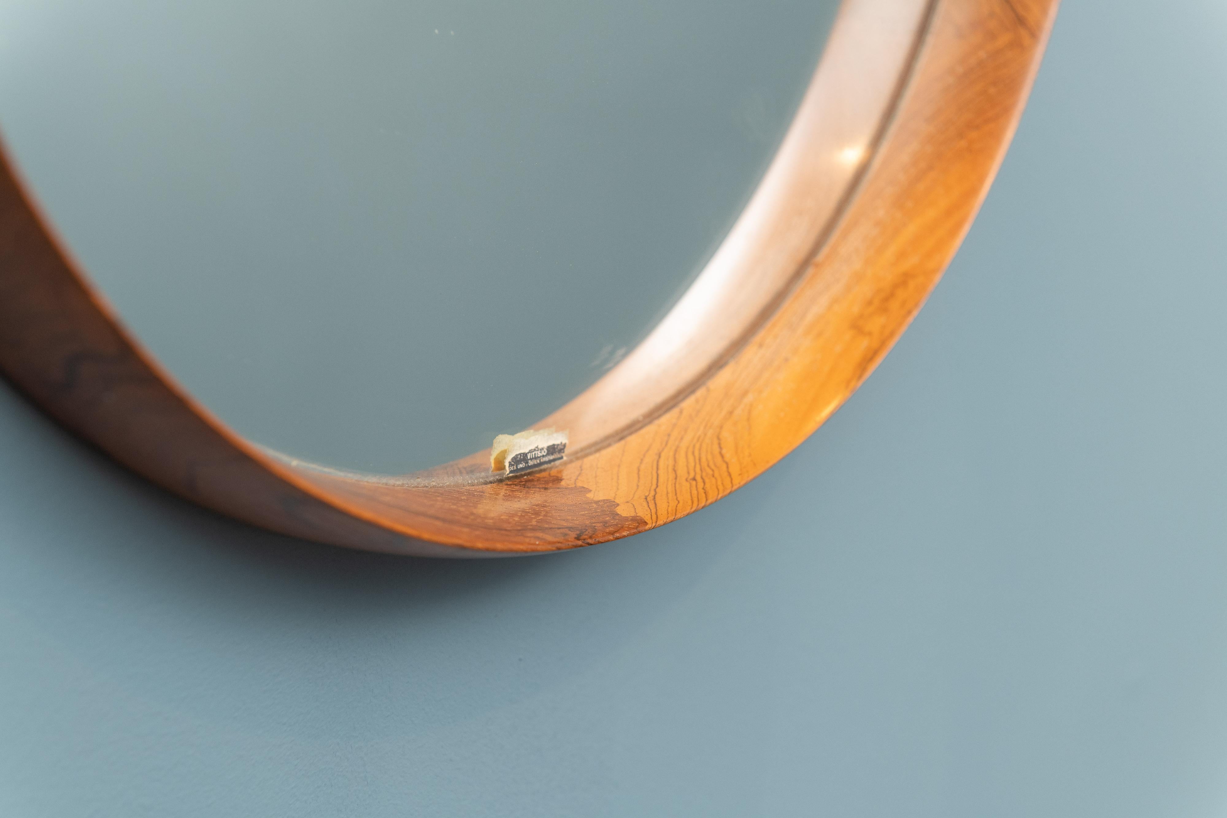 Round mirror in teak and leather designed by Uno & Östen Kristiansson. Produced by Luxus in Vittsjö, Sweden.