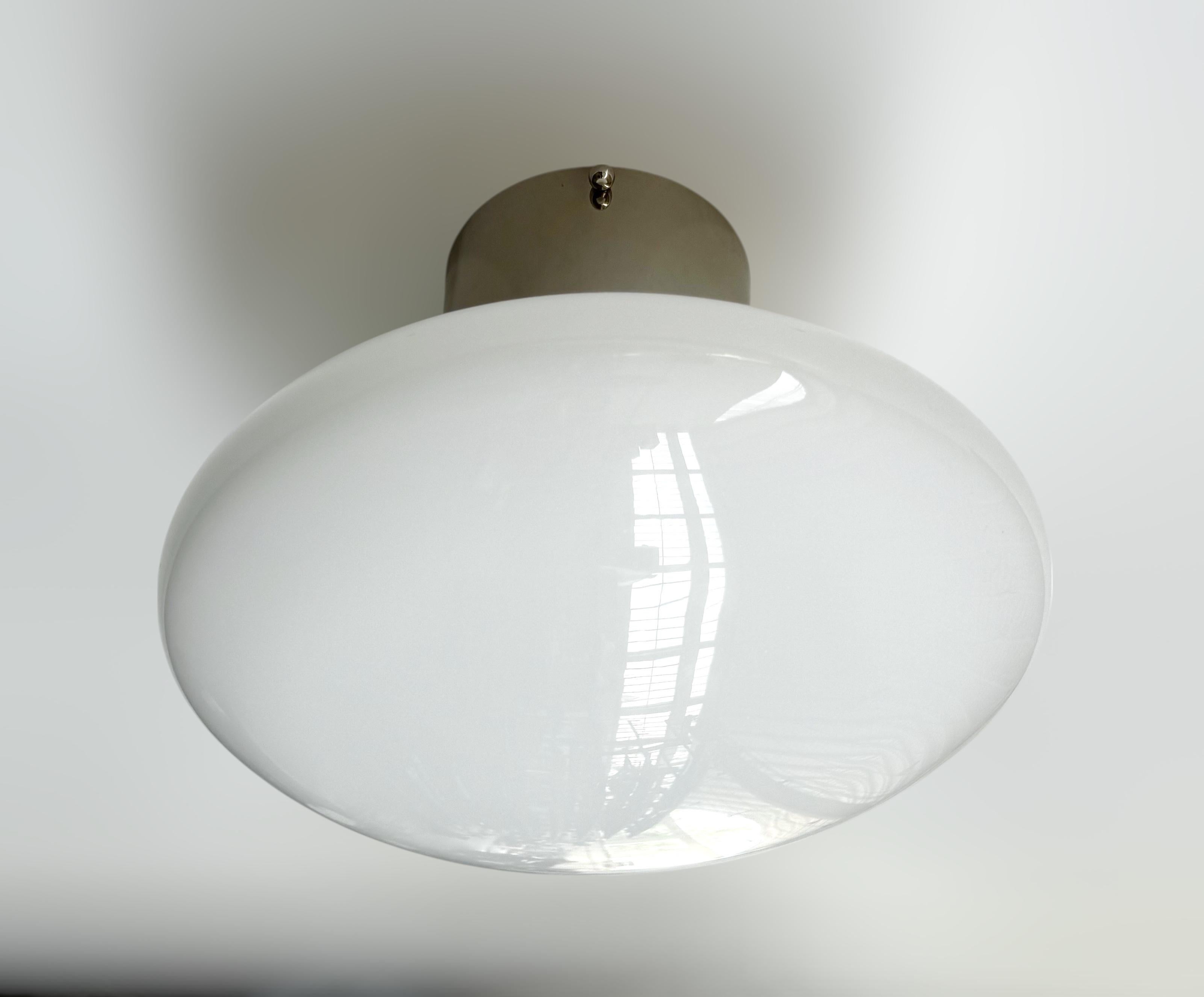 Italian flush mount with Murano glass shade and brass frame shown in polished nickel finish / Made in Italy
Designed by Fabio Ltd, inspired by Angelo Lelli and Arredoluce styles
1 light / E12 or E14 type / max 40W each
Diameter: 12 inches / Height:
