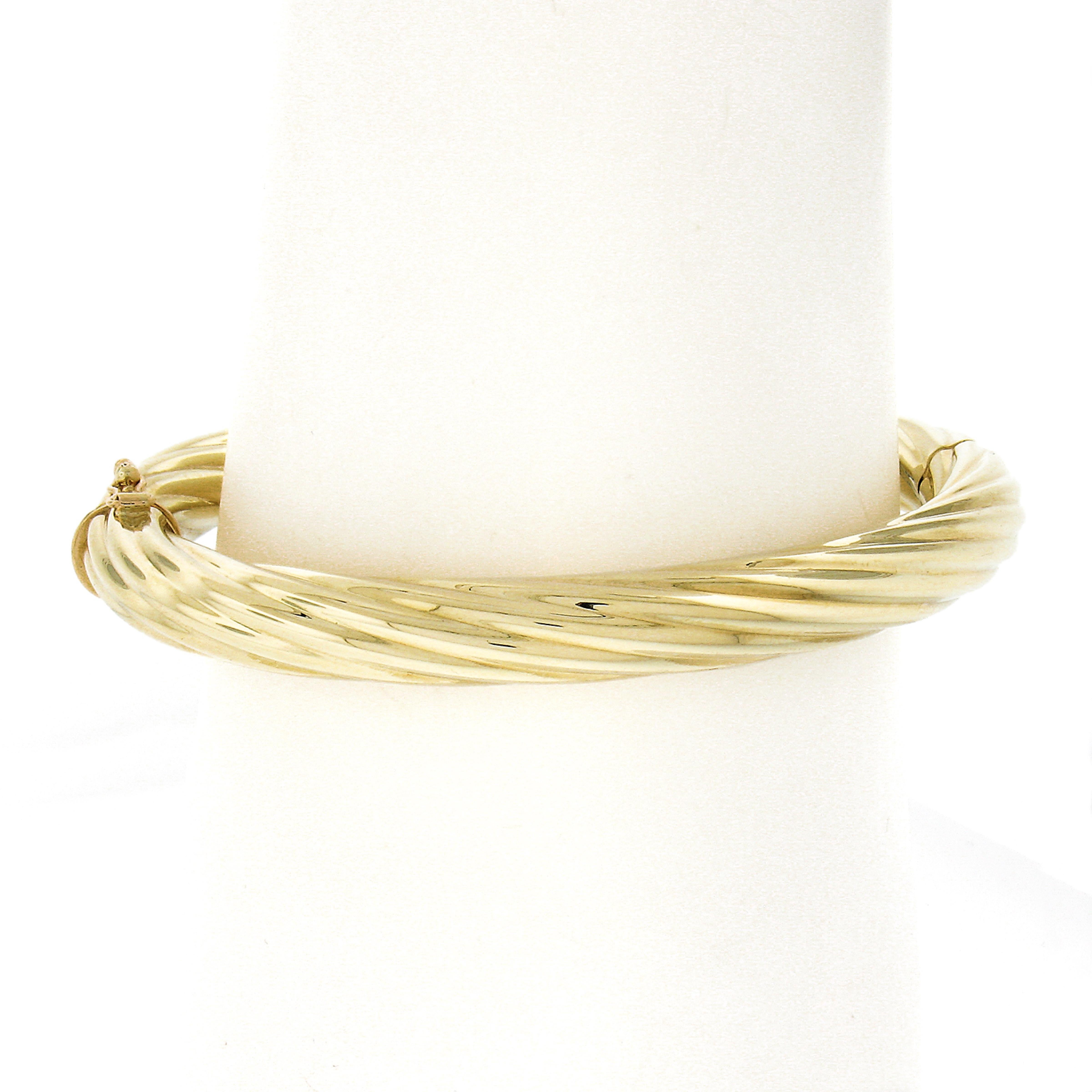 Material: Solid 14K Yellow Gold
Weight: 21 Grams
Type: Hinged Open Bangle Bracelet
Length: Will fit up to a 7.25 inch wrist (fitted on a wrist)
Clasp: Push Clasp w/ Safety Latch
Width: 7.9mm 
Thickness: 7.8mm rise off the wrist (approx.)
Stamp: 14K