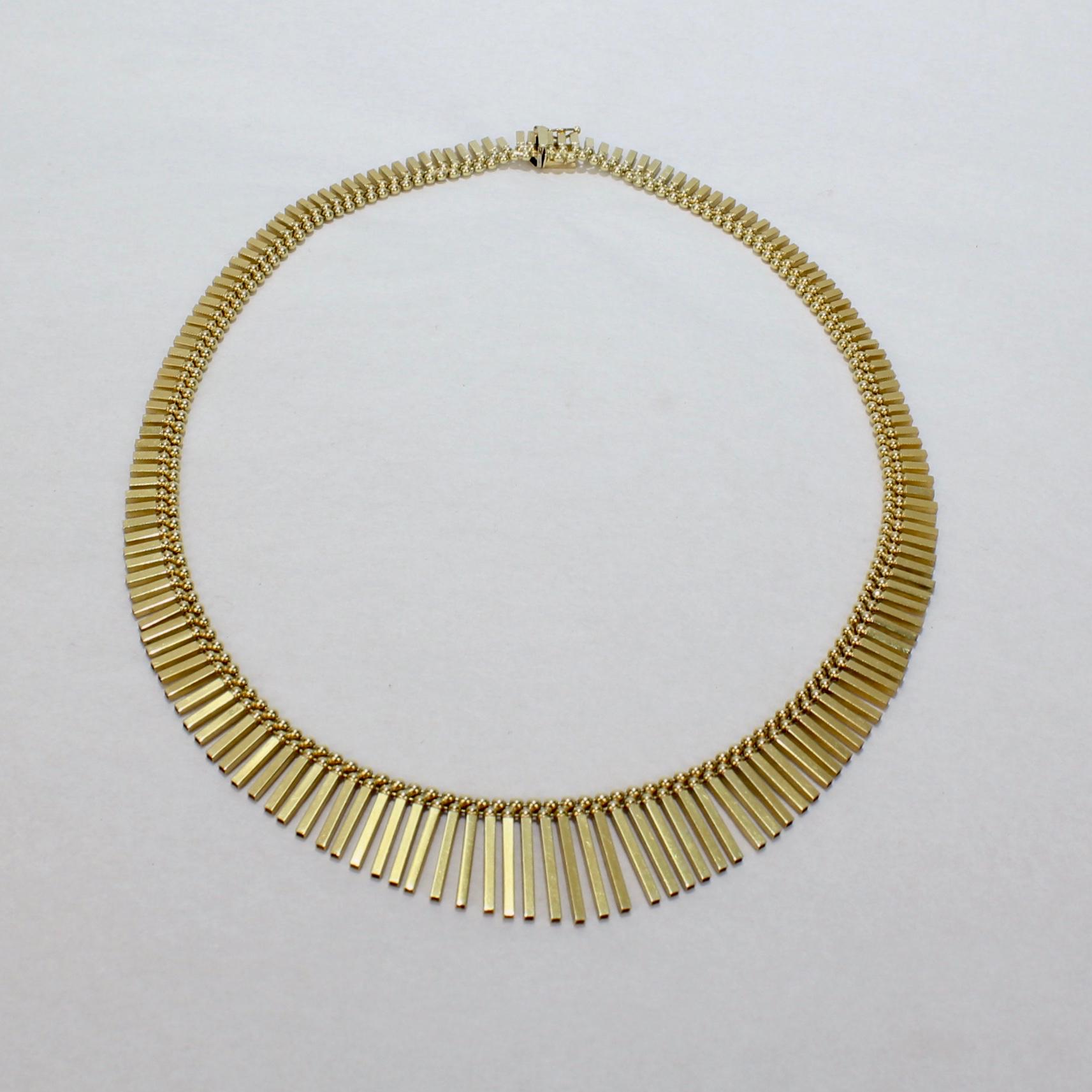 A wonderful graduated Fringe necklace by UnoAErre.

In 14K gold with graduated, alternating polished and textured open-ended rods suspended from a double strand of beads.

UnoAErre Italia is a renowned goldsmith and jeweler based in Arezzo, Italy.