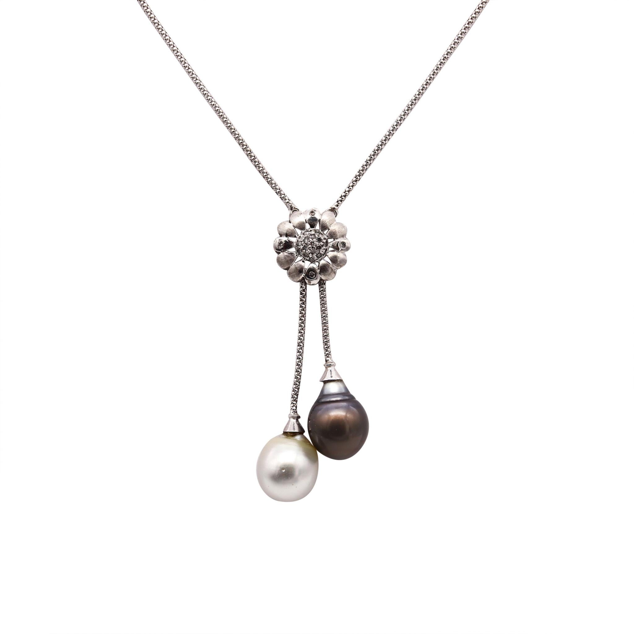 Italian necklace designed by UnoAerre.

Beautiful piece, crafted in Italy in solid white gold of 14 karats. This lariat necklace is mounted with a pair of very fine South Sea pearls; a gray-black of 14.5 mm and a white of 14 mm.

The rosette in the