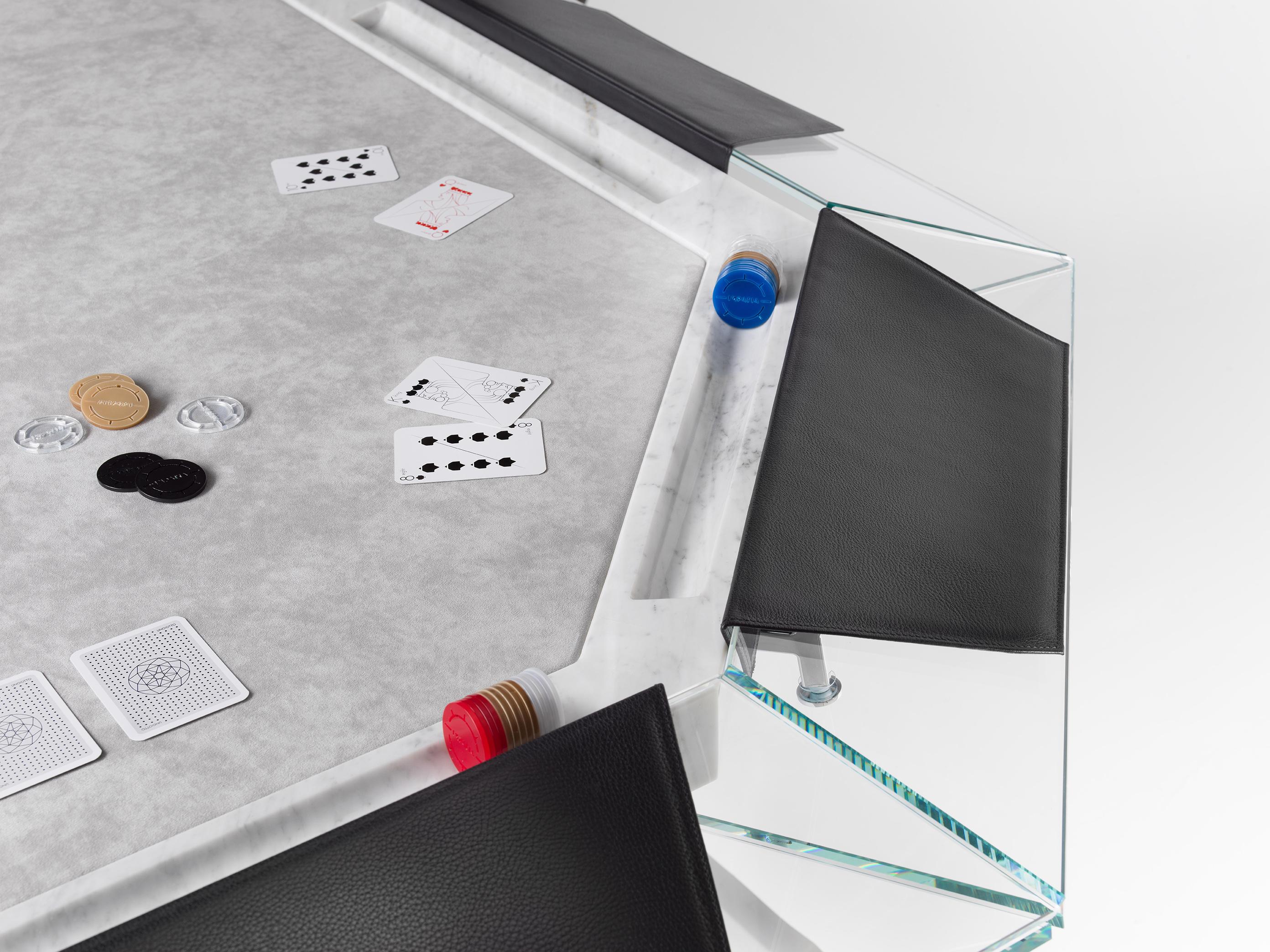 Unootto reinterprets the traditional professional poker table, making the A-game stylish and sophisticated.

This one-of-a-kind 10-player poker table features a unique low-iron glass top edge supported by an inner Italian marble top, finished with