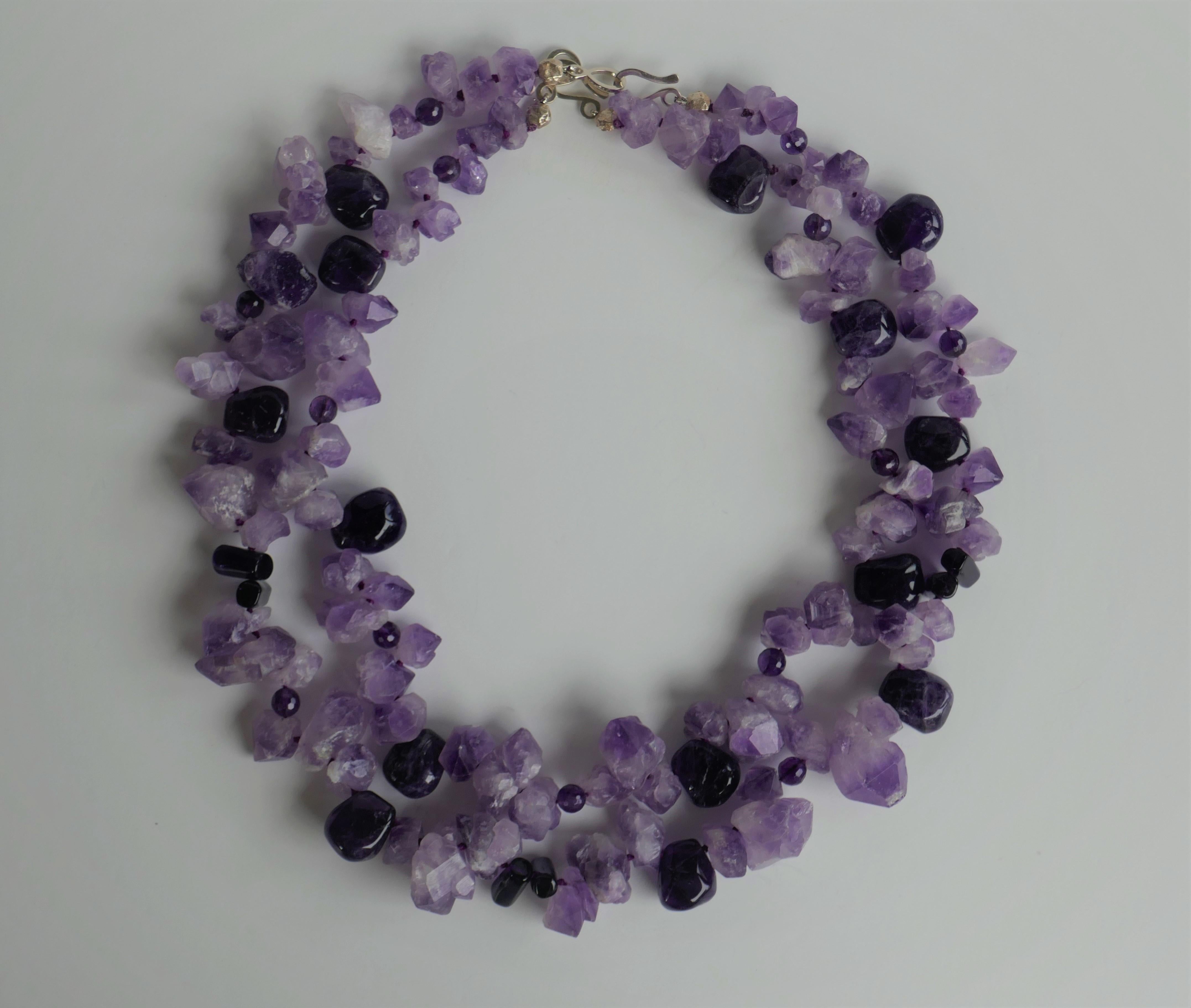 This two strand necklace is made of rough unpolished amethyst nuggets and dark polished amethyst in different shapes. The necklaces may be worn together or alone giving you the option. It is definitely a statement necklace. It is knotted on purple