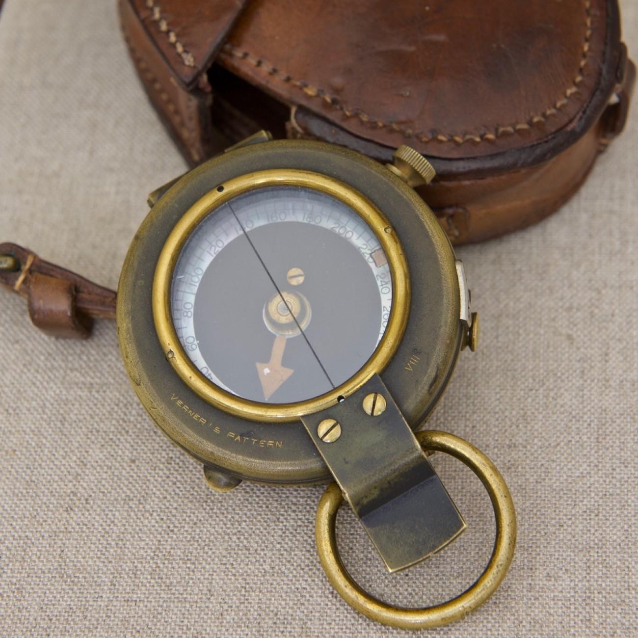 A type VIII ‘Verner’s Pattern’ military compass. This British military compass is called Verner's pattern after its designer's name, Colonel William Willoughby Cole Verner. 
It has a brass case, Mother of Pearl dial (to enhance reading in low level
