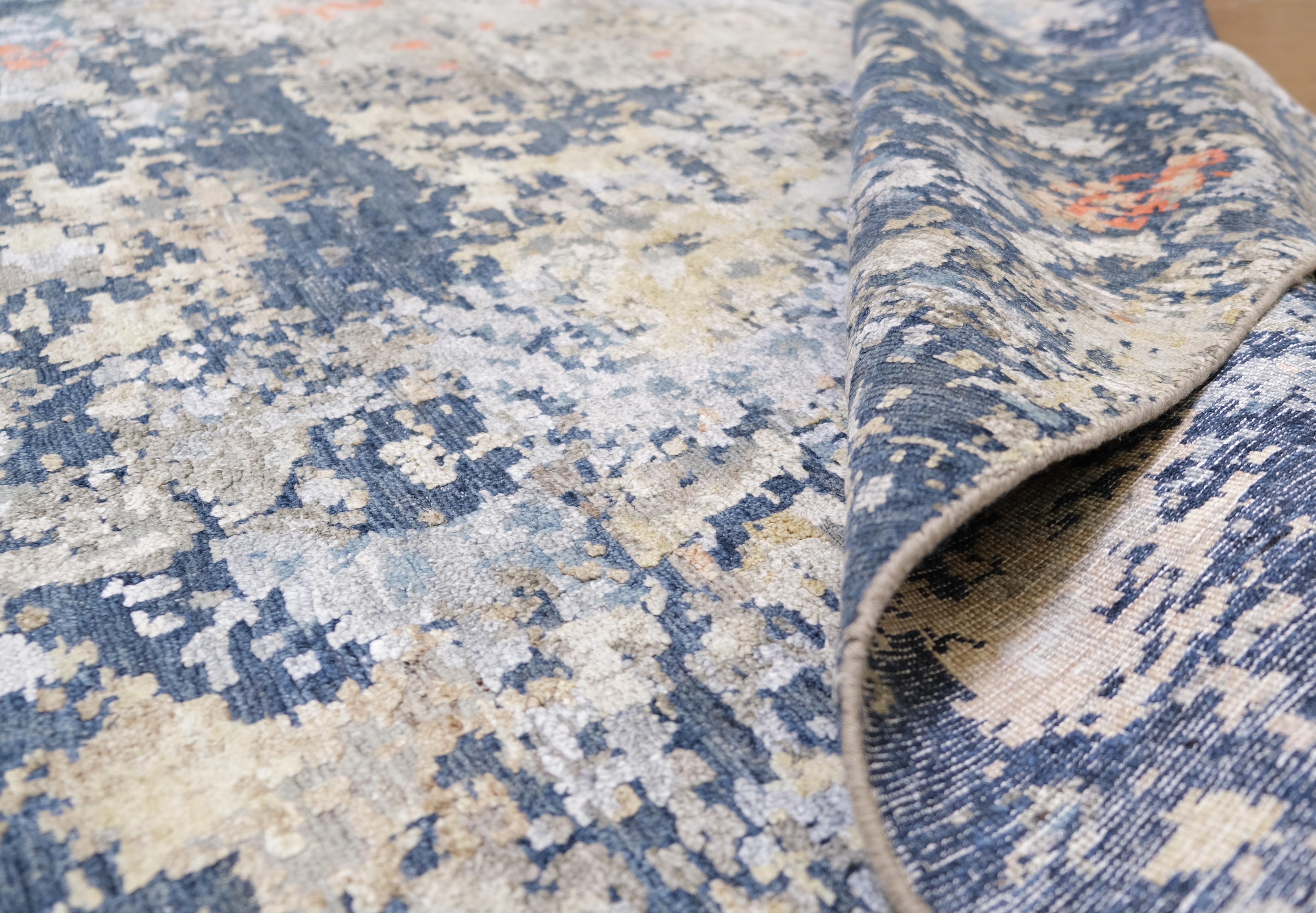 Infondi nei tuoi interni l'eleganza contemporanea di questo tappeto in lana e bambù annodato a mano, realizzato con maestria. Caratterizzato da uno splendido disegno astratto, questo tappeto incorpora una tavolozza dinamica di blu navy, beige,